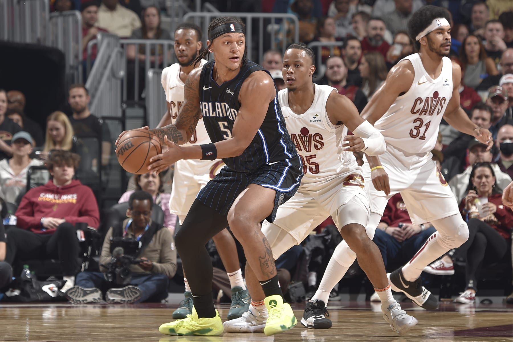 CLEVELAND, OH - FEBRUARY 22:  Paolo Banchero #5 of the Orlando Magic looks to pass the ball during the game against the Cleveland Cavaliers on February 22, 2024 at Rocket Mortgage FieldHouse in Cleveland, Ohio. NOTE TO USER: User expressly acknowledges and agrees that, by downloading and/or using this Photograph, user is consenting to the terms and conditions of the Getty Images License Agreement. Mandatory Copyright Notice: Copyright 2024 NBAE (Photo by David Liam Kyle/NBAE via Getty Images)