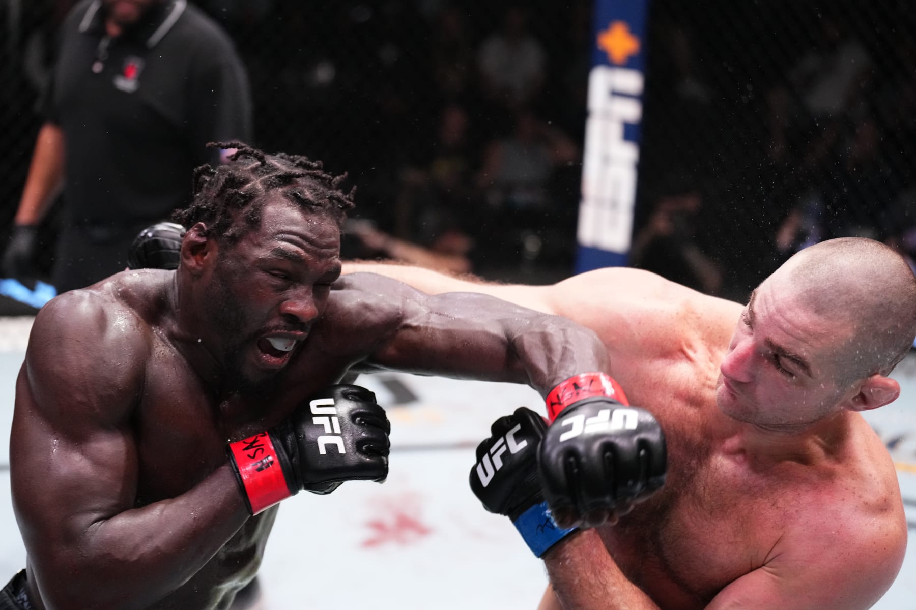 LAS VEGAS, NEVADA - DECEMBER 17: (L-R) Jared Cannonier punches Sean Strickland in a middleweight fight during the UFC Fight Night event at UFC APEX on December 17, 2022 in Las Vegas, Nevada. (Photo by Chris Unger/Zuffa LLC)