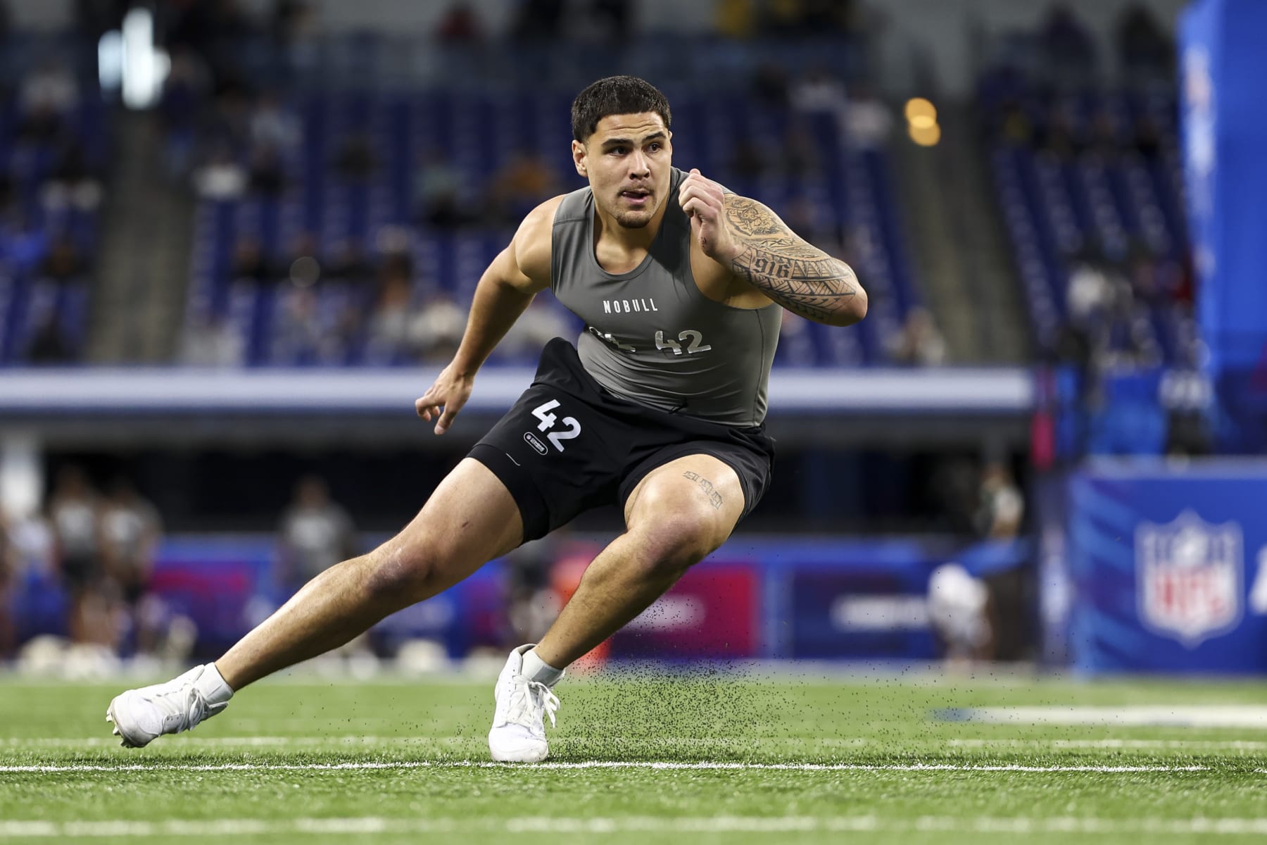 INDIANAPOLIS, INDIANA - FEBRUARY 29: Laiatu Latu #DL42 of UCLA participates in a drill during the NFL Combine at Lucas Oil Stadium on February 29, 2024 in Indianapolis, Indiana. (Photo by Kevin Sabitus/Getty Images)