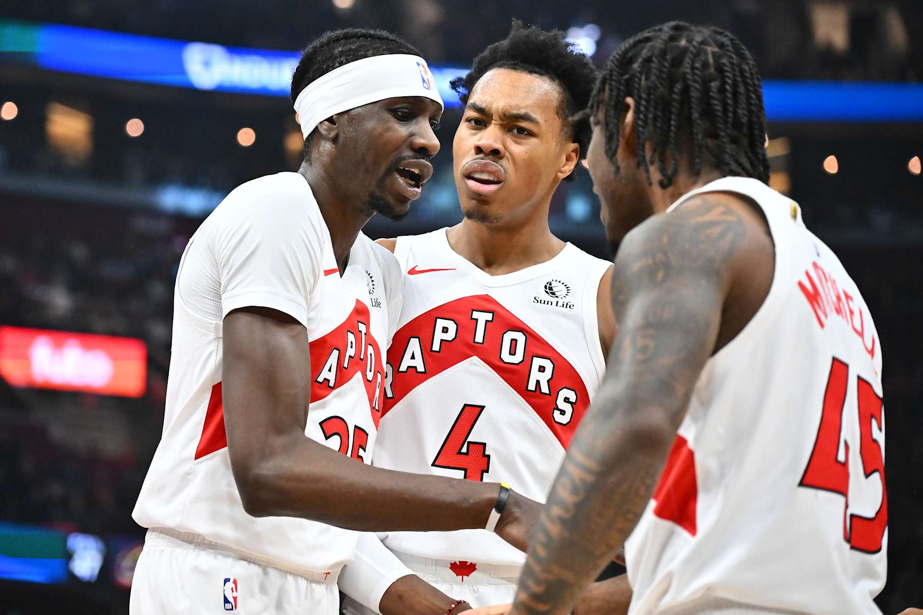CLEVELAND, OHIO - JANUARY 09: Chris Boucher #25 Scottie Barnes #4 and Davion Mitchell #45 of the Toronto Raptors celebrate during the first quarter against the Cleveland Cavaliers at Rocket Mortgage Fieldhouse on January 09, 2025 in Cleveland, Ohio. NOTE TO USER: User expressly acknowledges and agrees that, by downloading and or using this photograph, User is consenting to the terms and conditions of the Getty Images License Agreement. (Photo by Jason Miller/Getty Images)