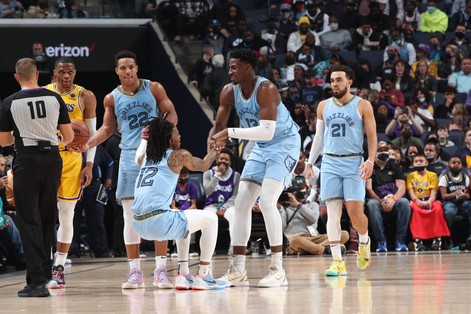 MEMPHIS, TN - DECEMBER 29: Ja Morant #12 of the Memphis Grizzlies is helped off the court by Desmond Bane #22 and Jaren Jackson Jr. #13 of the Memphis Grizzlies during a game against the Los Angeles Lakers on December 29, 2021 at FedExForum in Memphis, Tennessee. NOTE TO USER: User expressly acknowledges and agrees that, by downloading and or using this photograph, User is consenting to the terms and conditions of the Getty Images License Agreement. Mandatory Copyright Notice: Copyright 2021 NBAE (Photo by Joe Murphy/NBAE via Getty Images)