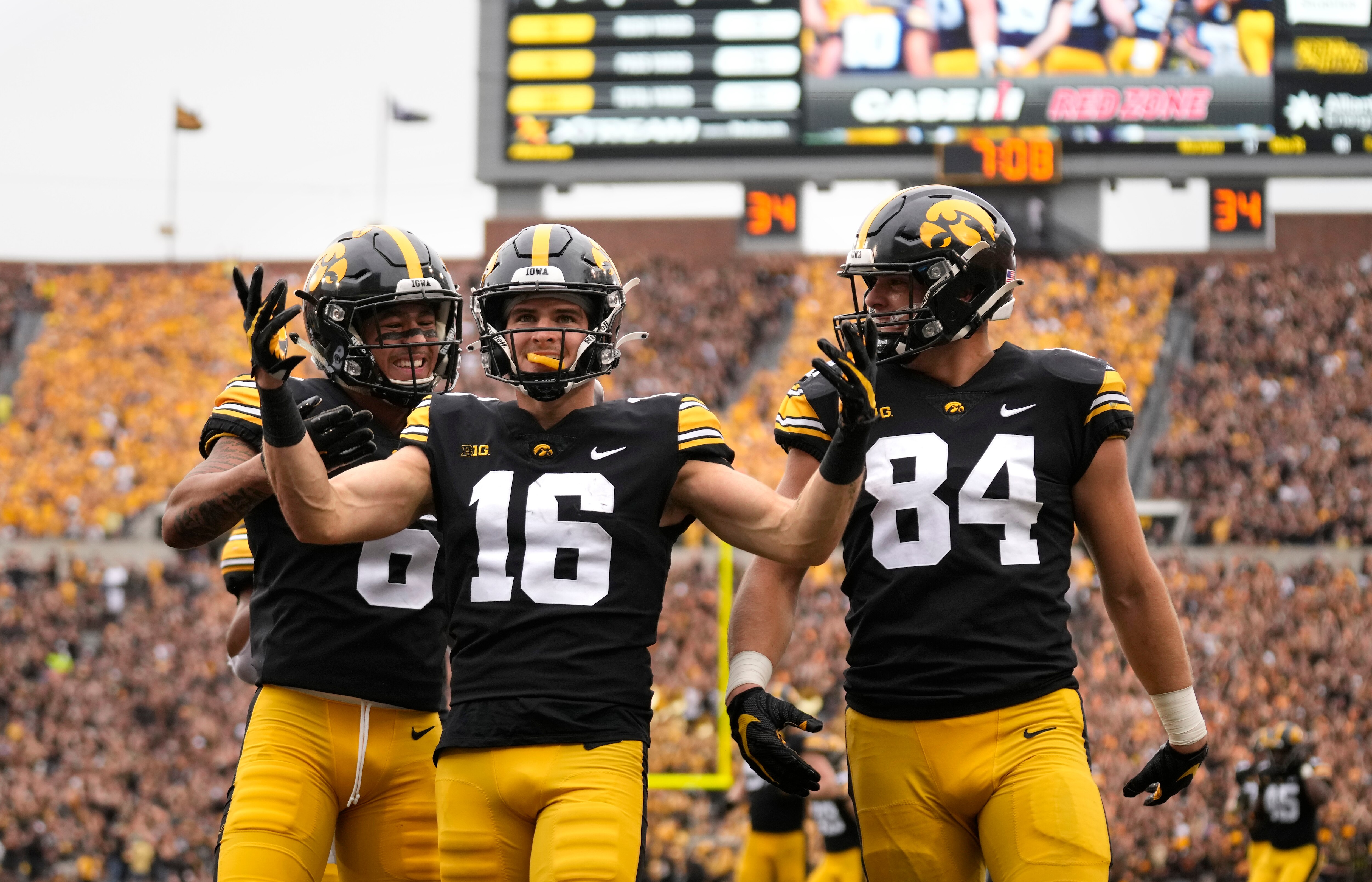 Iowa wide receiver Charlie Jones (16) celebrates his touchdown with receiver Keagan Johnson (6) and tight end Sam LaPorta (84) during the first half of an NCAA college football game against Penn State, Saturday, Oct. 9, 2021, in Iowa City, Iowa. (AP Photo/Matthew Putney)