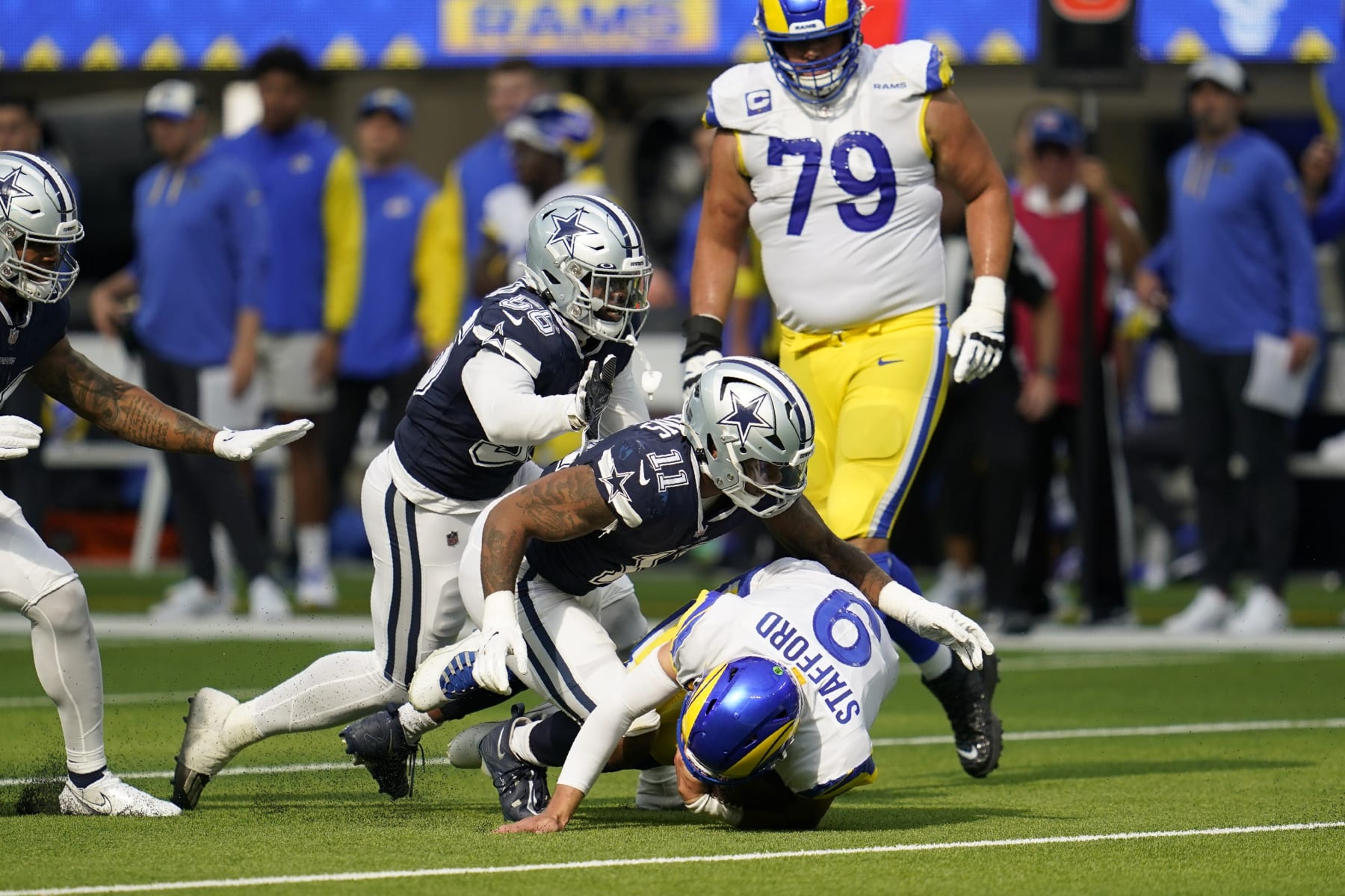 Dallas Cowboys linebacker Micah Parsons (11) sacks Los Angeles Rams quarterback Matthew Stafford (9) and defensive end Dante Fowler Jr. (56) and Rams offensive tackle Rob Havenstein (79) look on in the second half of an NFL football game, Sunday, Oct. 9, 2022, in Inglewood, Calif. (AP Photo/Ashley Landis)