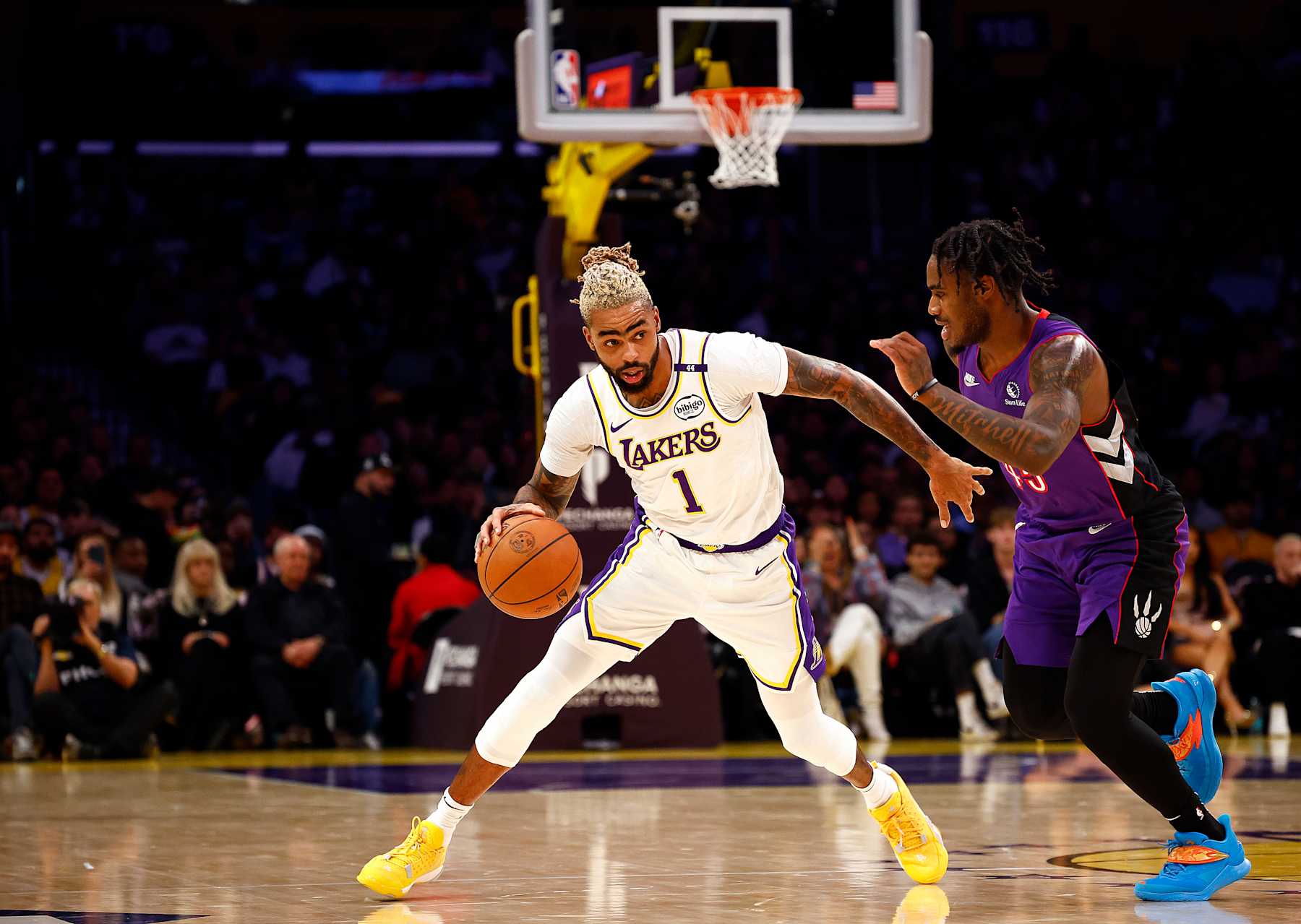 LOS ANGELES, CALIFORNIA - NOVEMBER 10:  D'Angelo Russell #1 of the Los Angeles Lakers controls the ball against Davion Mitchell #45 of the Toronto Raptors in the first half at Crypto.com Arena on November 10, 2024 in Los Angeles, California.  NOTE TO USER: User expressly acknowledges and agrees that, by downloading and/or using this photograph, user is consenting to the terms and conditions of the Getty Images License Agreement. (Photo by Ronald Martinez/Getty Images)