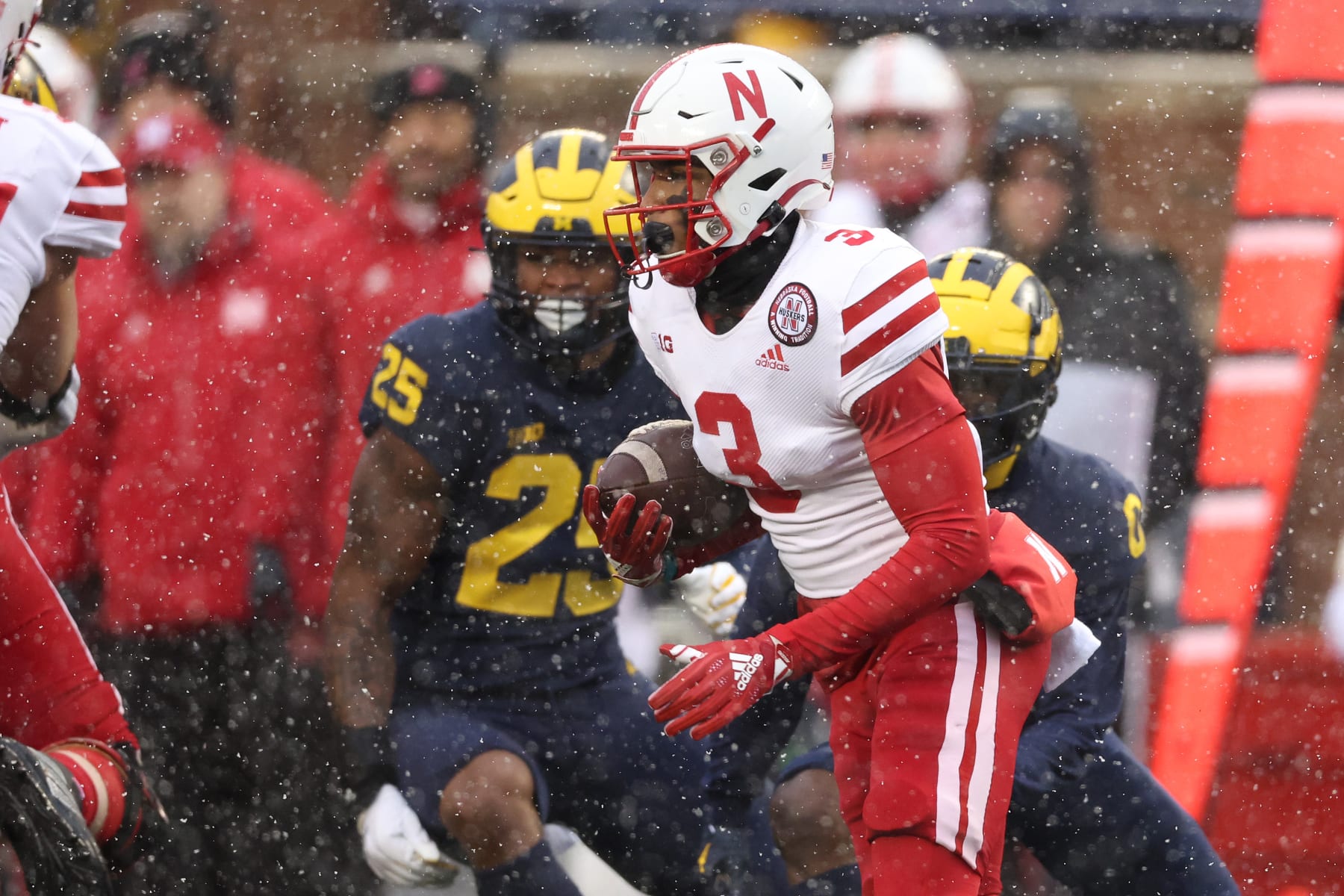 ANN ARBOR, MICHIGAN - NOVEMBER 12: Trey Palmer #3 of the Nebraska Cornhuskers looks for yards after a first half catch in front of Junior Colson #25 of the Michigan Wolverines at Michigan Stadium on November 12, 2022 in Ann Arbor, Michigan. (Photo by Gregory Shamus/Getty Images)