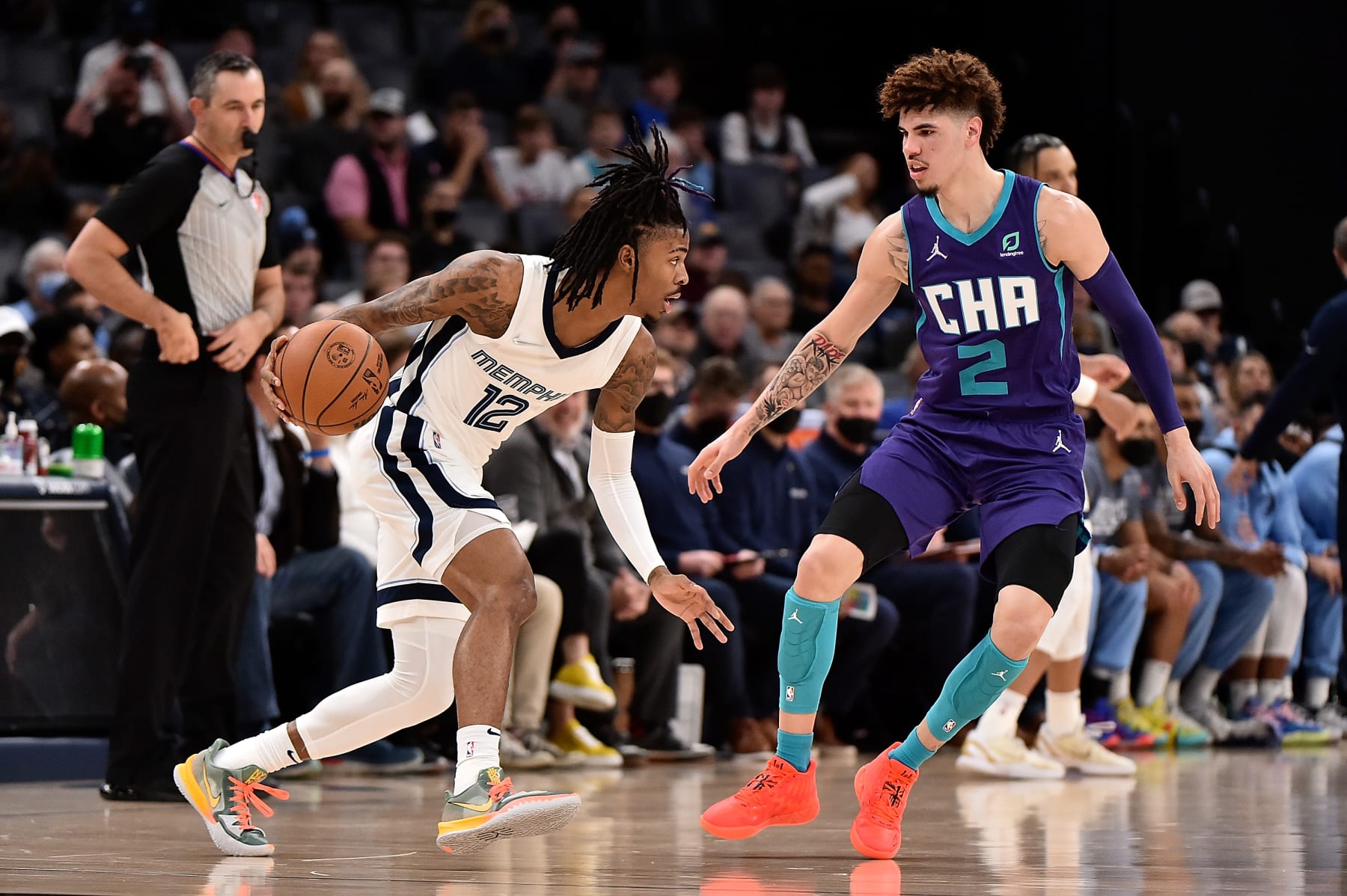 MEMPHIS, TENNESSEE - NOVEMBER 10: Ja Morant #12 of the Memphis Grizzlies handles the ball against LaMelo Ball #2 of the Charlotte Hornets during the game at FedExForum on November 10, 2021 in Memphis, Tennessee. NOTE TO USER: User expressly acknowledges and agrees that, by downloading and or using this photograph, User is consenting to the terms and conditions of the Getty Images License Agreement. (Photo by Justin Ford/Getty Images)