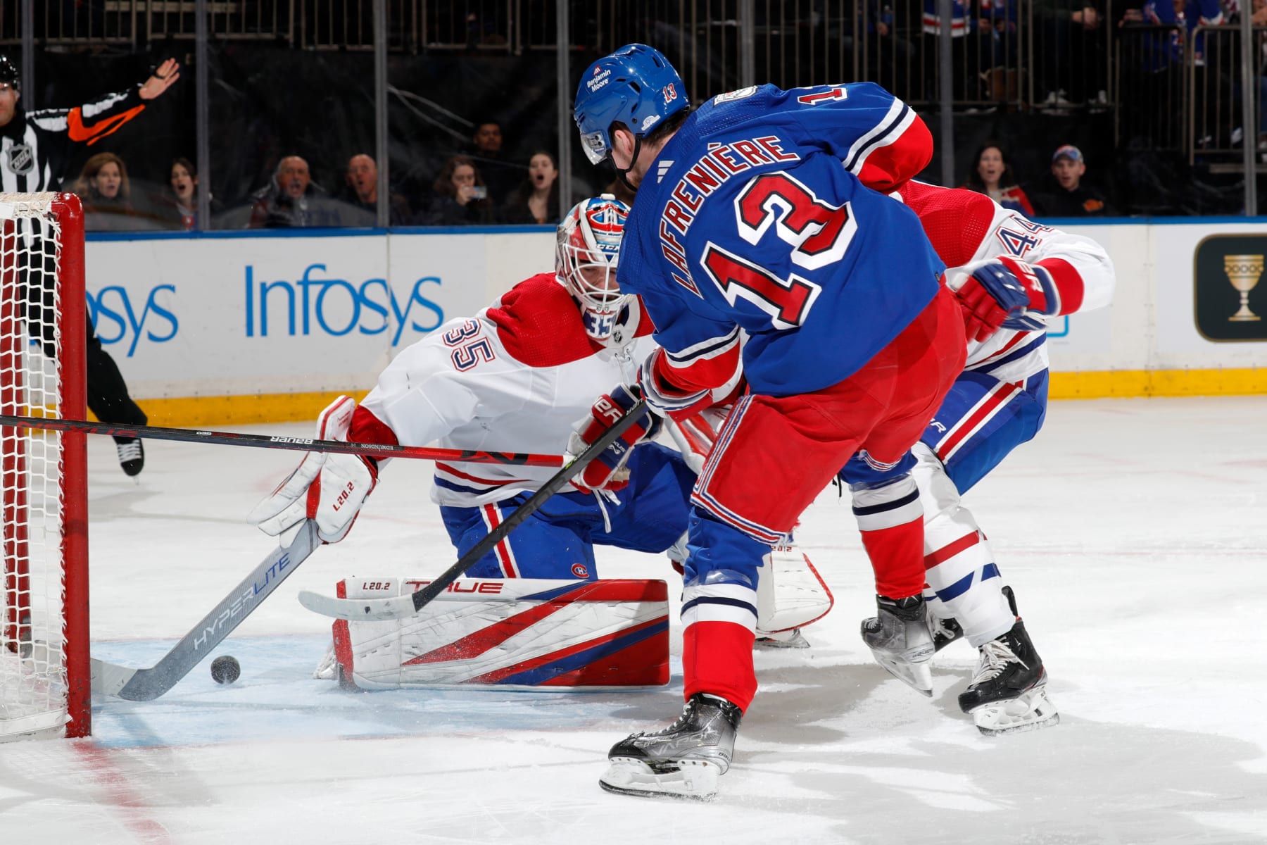 NEW YORK, NEW YORK - JANUARY 15:  Sam Montembeault #35 of the Montreal Canadiens makes a stick save against Alexis Lafreniere #13 of the New York Rangers at Madison Square Garden on January 15, 2023 in New York City. (Photo by Jared Silber/NHLI via Getty Images)