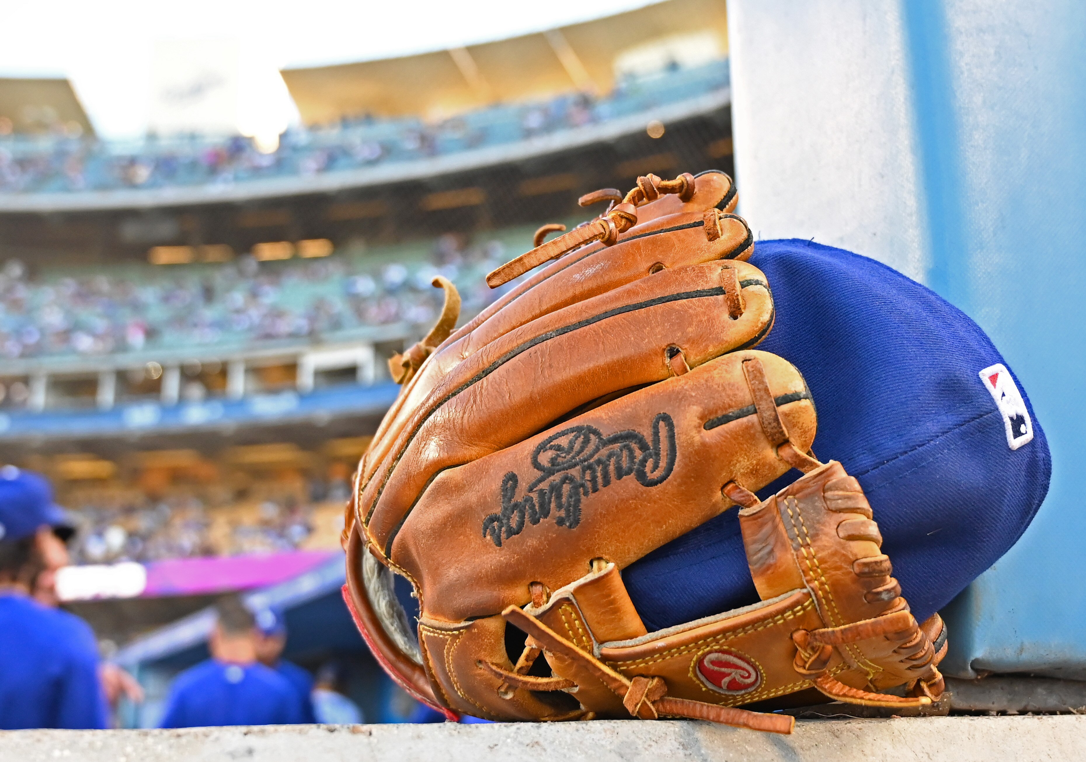 LOS ANGELES, CA - JULY 20: Detailed view of a glove and hat in the dugout during the game between the Los Angeles Dodgers and the San Francisco Giants at Dodger Stadium on July 20, 2021 in Los Angeles, California. (Photo by Jayne Kamin-Oncea/Getty Images)