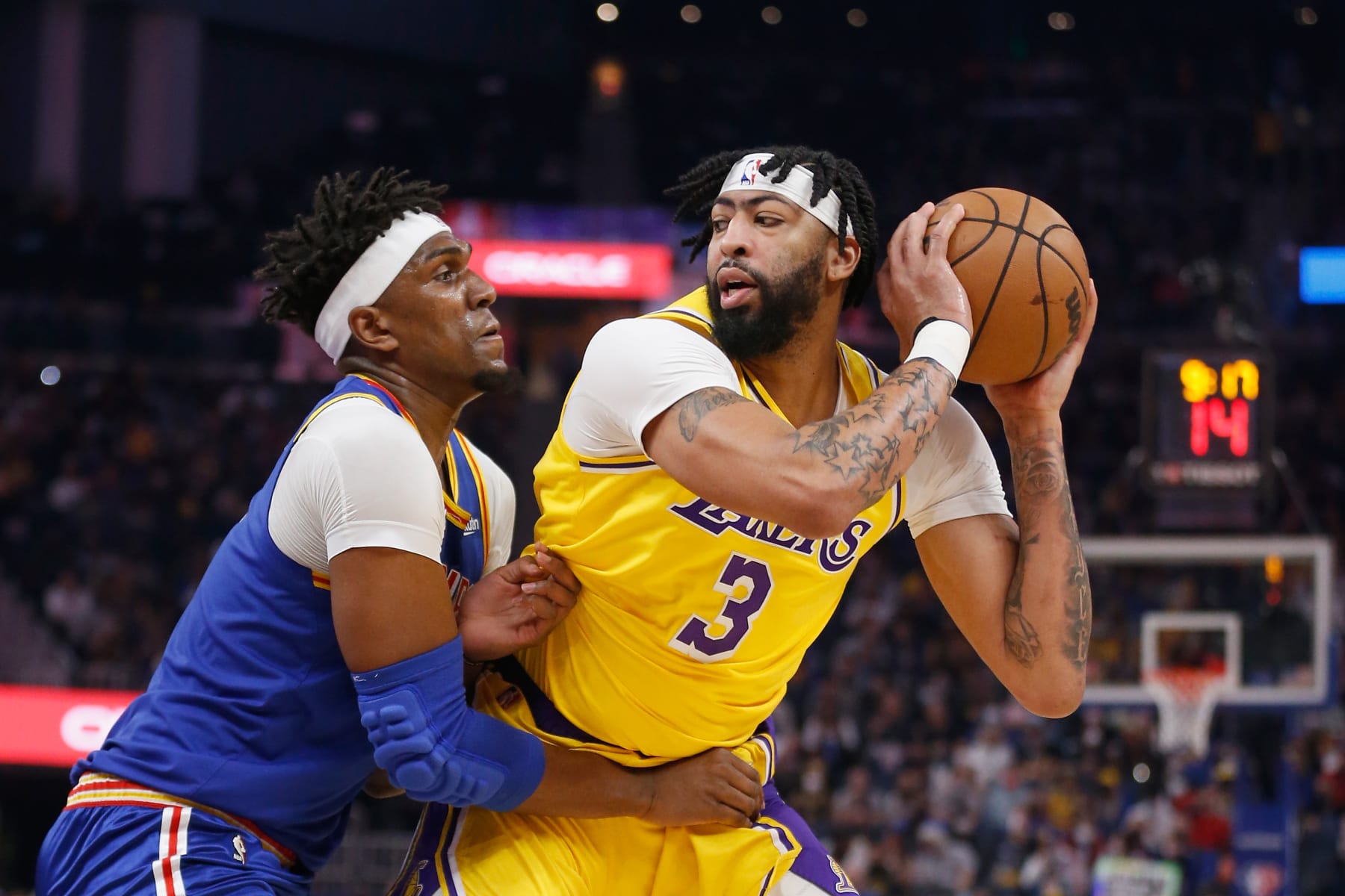 SAN FRANCISCO, CALIFORNIA - FEBRUARY 12: Anthony Davis #3 of the Los Angeles Lakers is guarded by Kevon Looney #5 of the Golden State Warriors in the first half against the Golden State Warriors at Chase Center on February 12, 2022 in San Francisco, California. NOTE TO USER: User expressly acknowledges and agrees that, by downloading and/or using this photograph, User is consenting to the terms and conditions of the Getty Images License Agreement. (Photo by Lachlan Cunningham/Getty Images)
