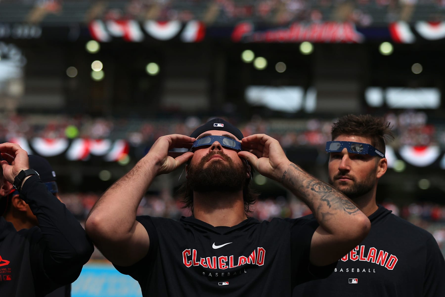 CLEVELAND, OHIO - APRIL 08: Hunter Gaddis #33 of the Cleveland Guardians looks up at the total solar eclipse before the home opener against the Chicago White Sox at Progressive Field on April 08, 2024 in Cleveland, Ohio. (Photo by Mike Lawrie/Getty Images)
