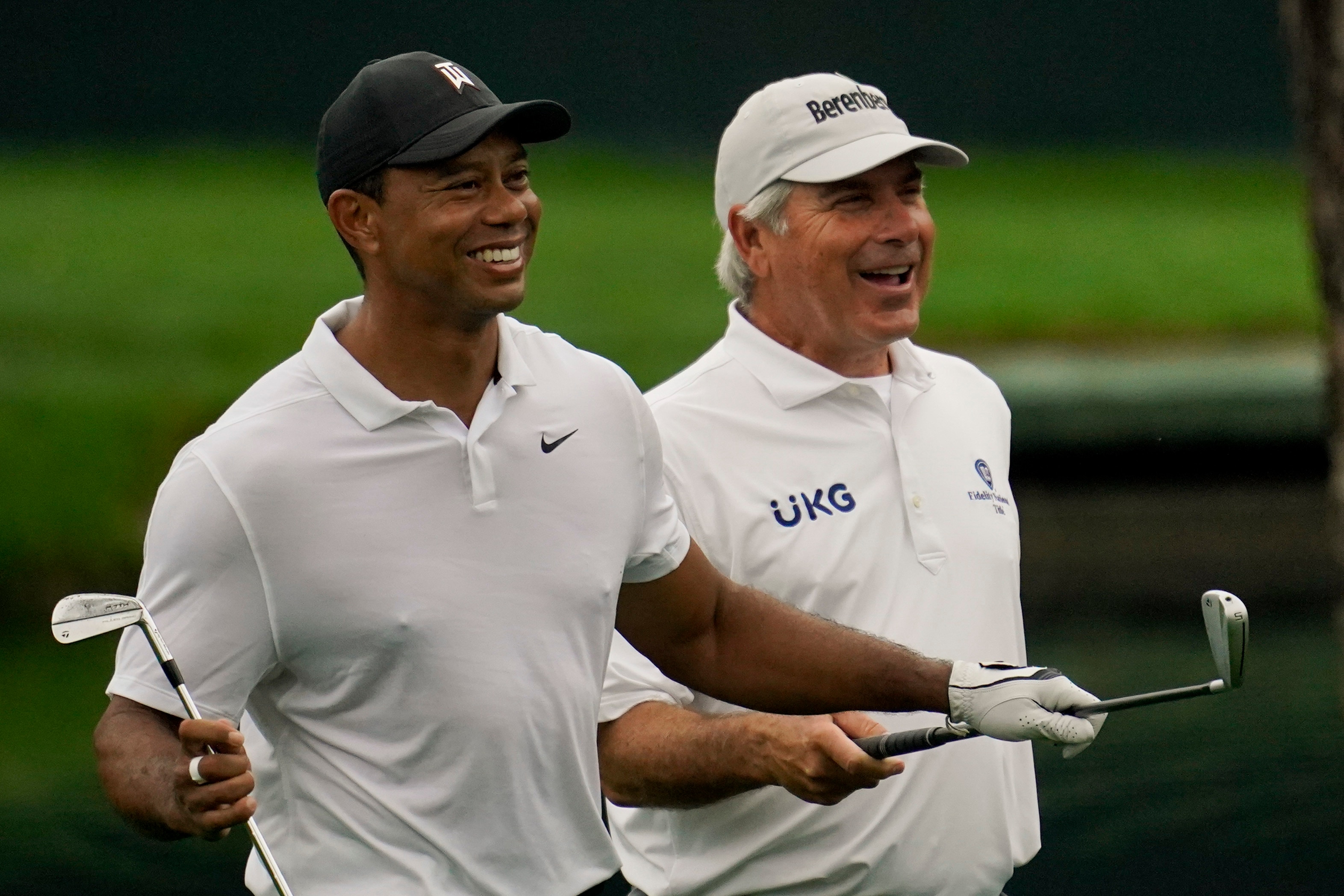 Tiger Woods walks with Fred Couples on the 16th hole during a practice round for the Masters golf tournament on Wednesday, April 6, 2022, in Augusta, Ga. (AP Photo/Robert F. Bukaty)