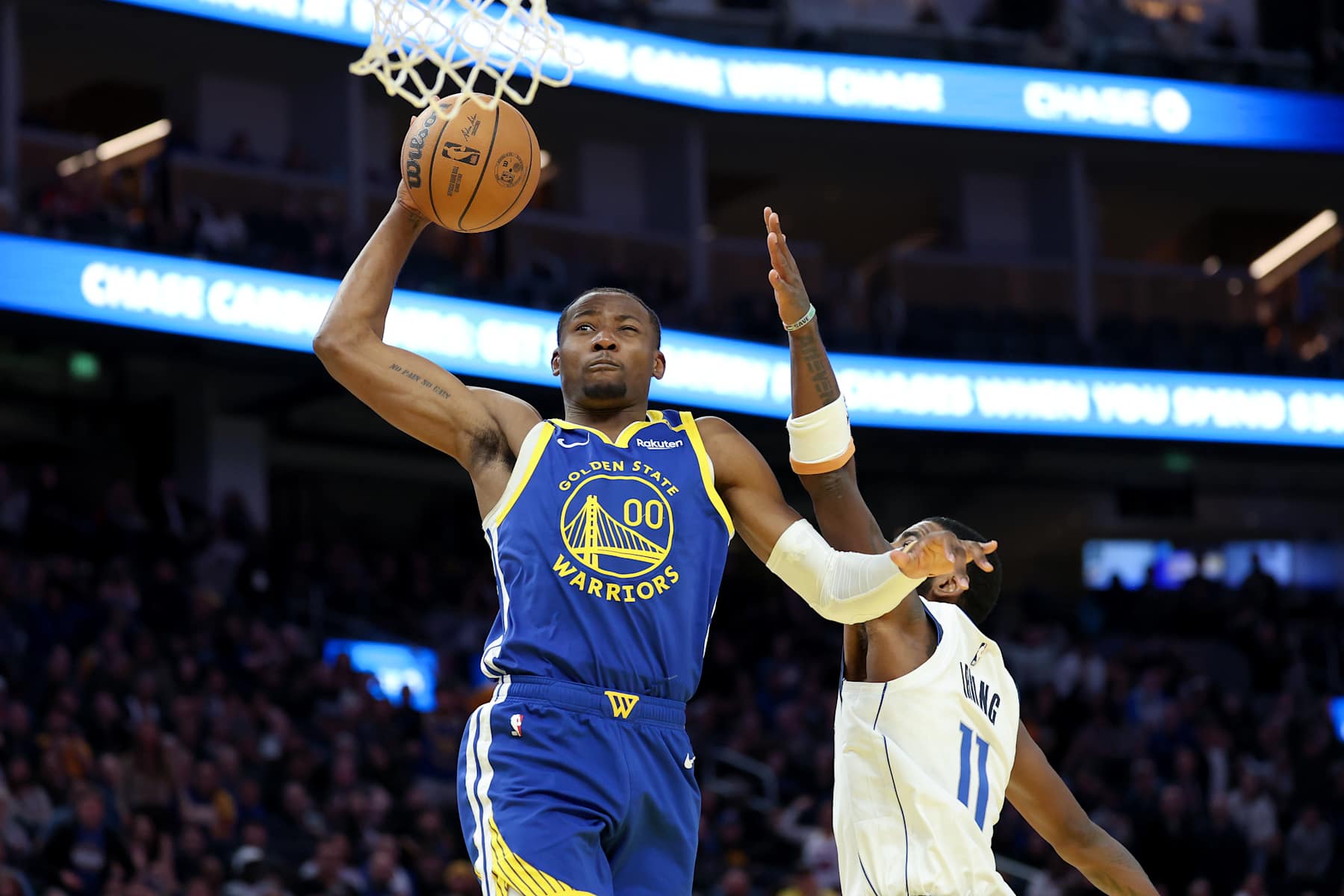 SAN FRANCISCO, CALIFORNIA - DECEMBER 15: Jonathan Kuminga #00 of the Golden State Warriors goes up for a dunk on Kyrie Irving #11 of the Dallas Mavericks in the second half at Chase Center on December 15, 2024 in San Francisco, California.  NOTE TO USER: User expressly acknowledges and agrees that, by downloading and/or using this photograph, user is consenting to the terms and conditions of the Getty Images License Agreement.   (Photo by Ezra Shaw/Getty Images)