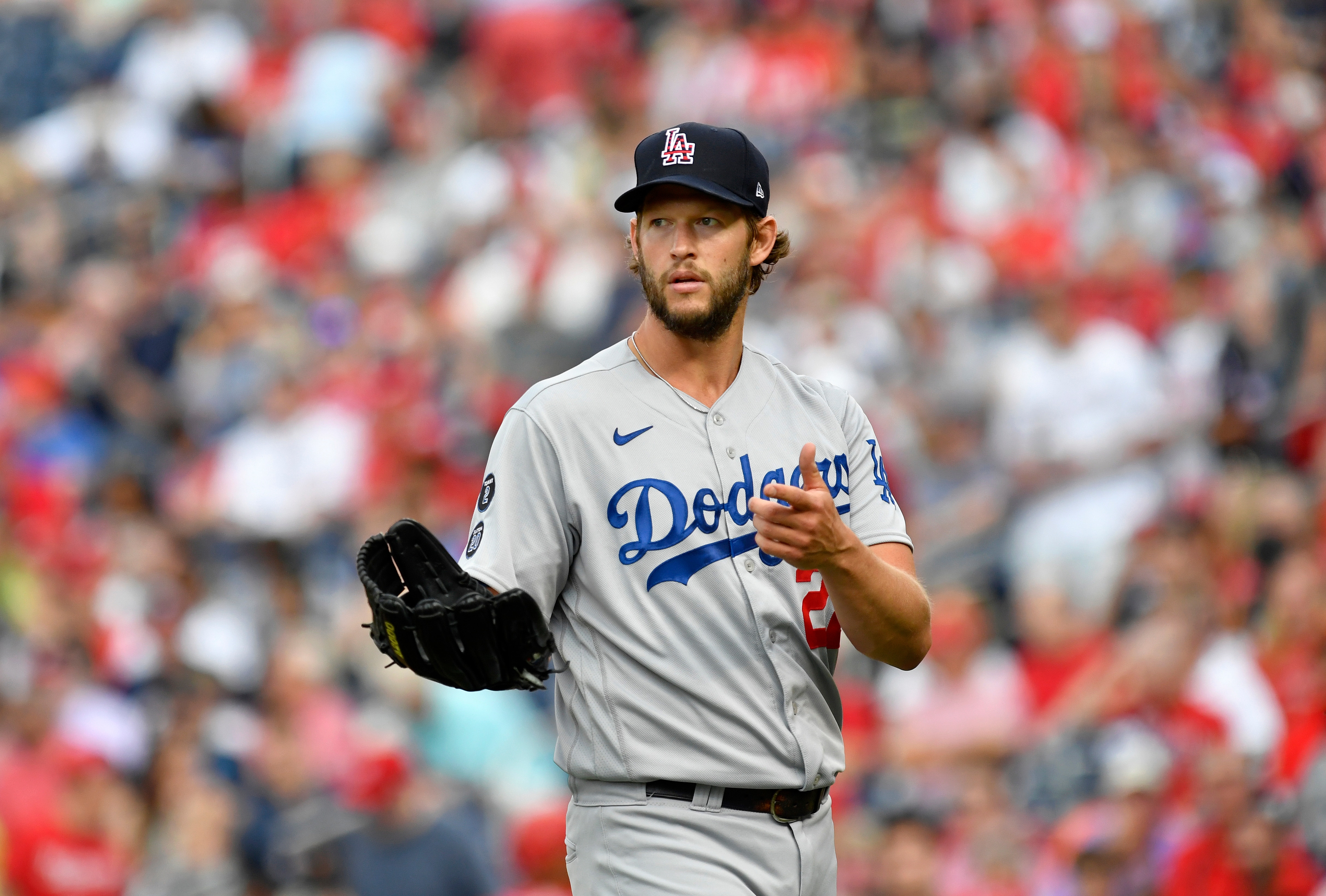 WASHINGTON, DC - JULY 03: Los Angeles Dodgers pitcher Clayton Kershaw (22) asks the umpires if they want to check him for foreign substances after an inning during the Los Angeles Dodgers versus Washington Nationals MLB game at Nationals Park on July 3, 2021 in Washington, D.C.. (Photo by Randy Litzinger/Icon Sportswire via Getty Images)