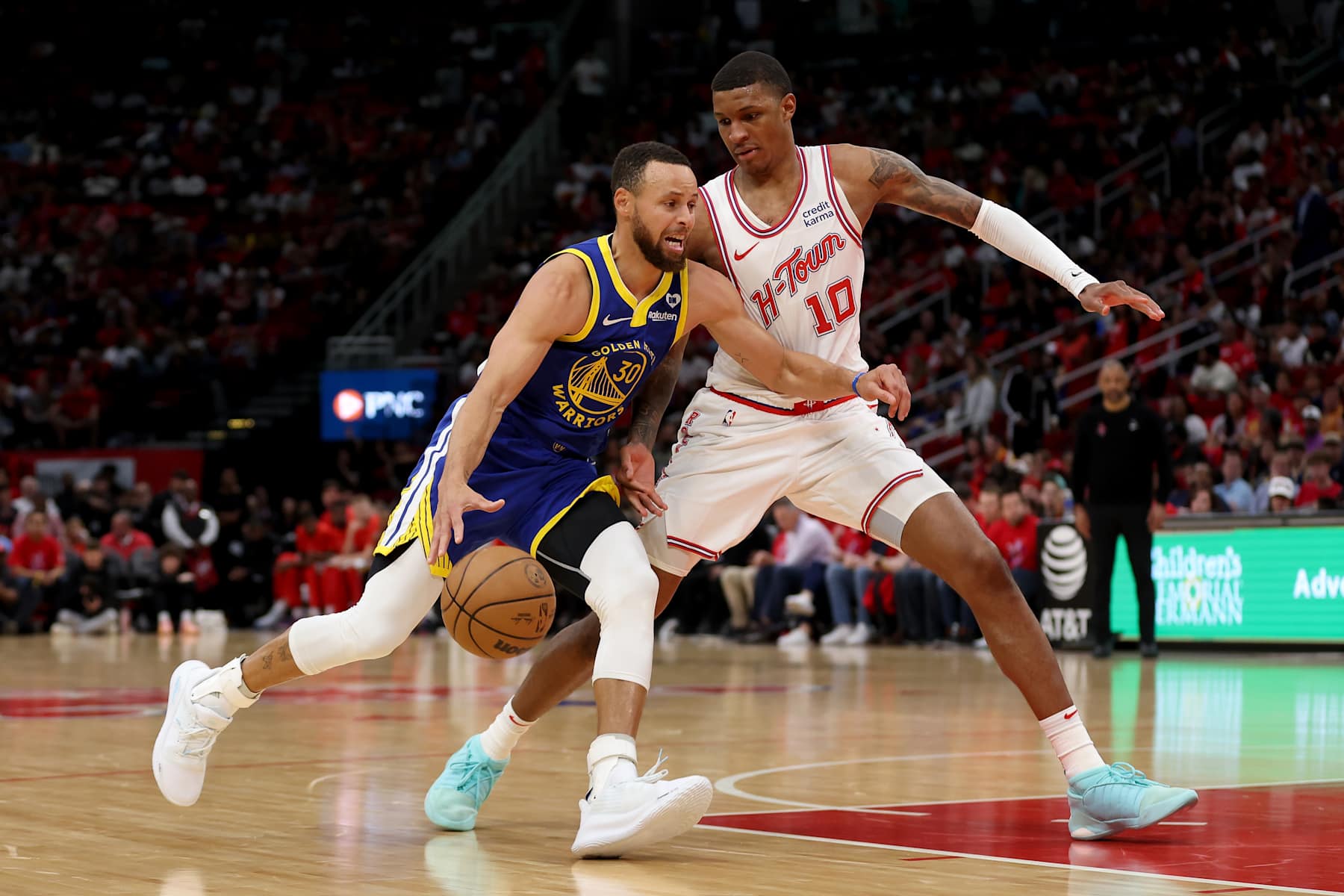 HOUSTON, TEXAS - APRIL 04: Stephen Curry #30 of the Golden State Warriors drives to the basket while defended by Jabari Smith Jr. #10 of the Houston Rockets in the second half at Toyota Center on April 04, 2024 in Houston, Texas.  NOTE TO USER: User expressly acknowledges and agrees that, by downloading and or using this photograph, User is consenting to the terms and conditions of the Getty Images License Agreement. (Photo by Tim Warner/Getty Images)