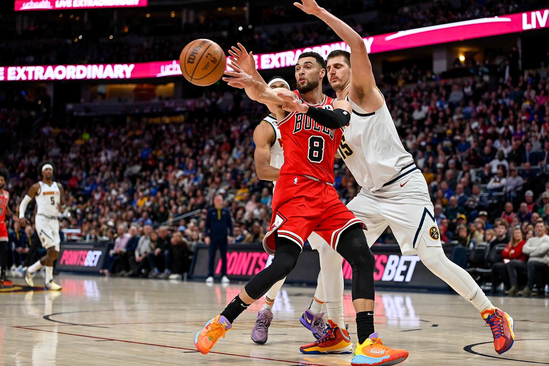 DENVER, CO - MARCH 8:  Zach LaVine #8 of the Chicago Bulls is covered by Nikola Jokic #15 of the Denver Nuggets in a game at Ball Arena on March 8, 2023 in Denver, Colorado. NOTE TO USER: User expressly acknowledges and agrees that, by downloading and or using this photograph, User is consenting to the terms and conditions of the Getty Images License Agreement. (Photo by Dustin Bradford/Getty Images)