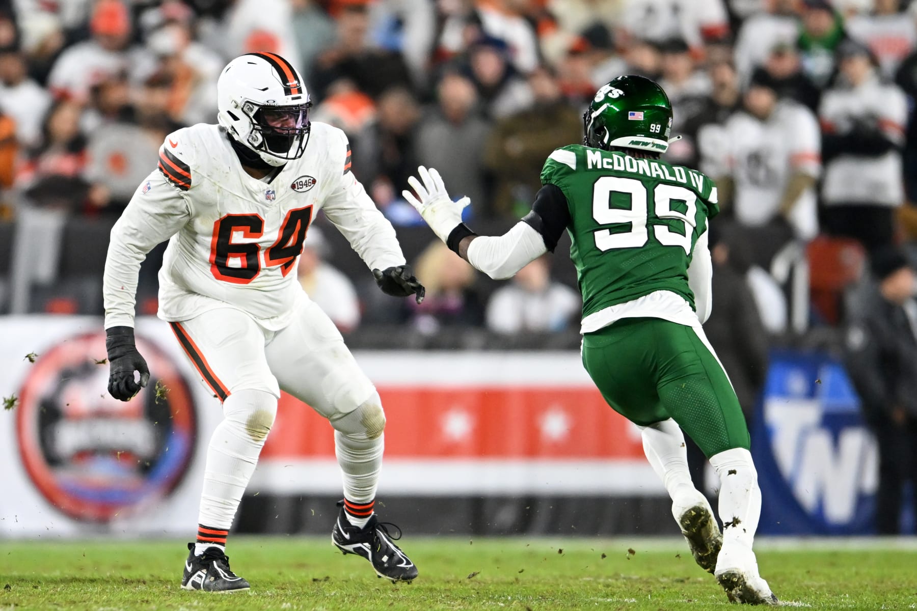 CLEVELAND, OHIO - DECEMBER 28: Geron Christian #64 of the Cleveland Browns blocks Will McDonald IV #99 of the New York Jets during the first half at Cleveland Browns Stadium on December 28, 2023 in Cleveland, Ohio. (Photo by Nick Cammett/Diamond Images via Getty Images)