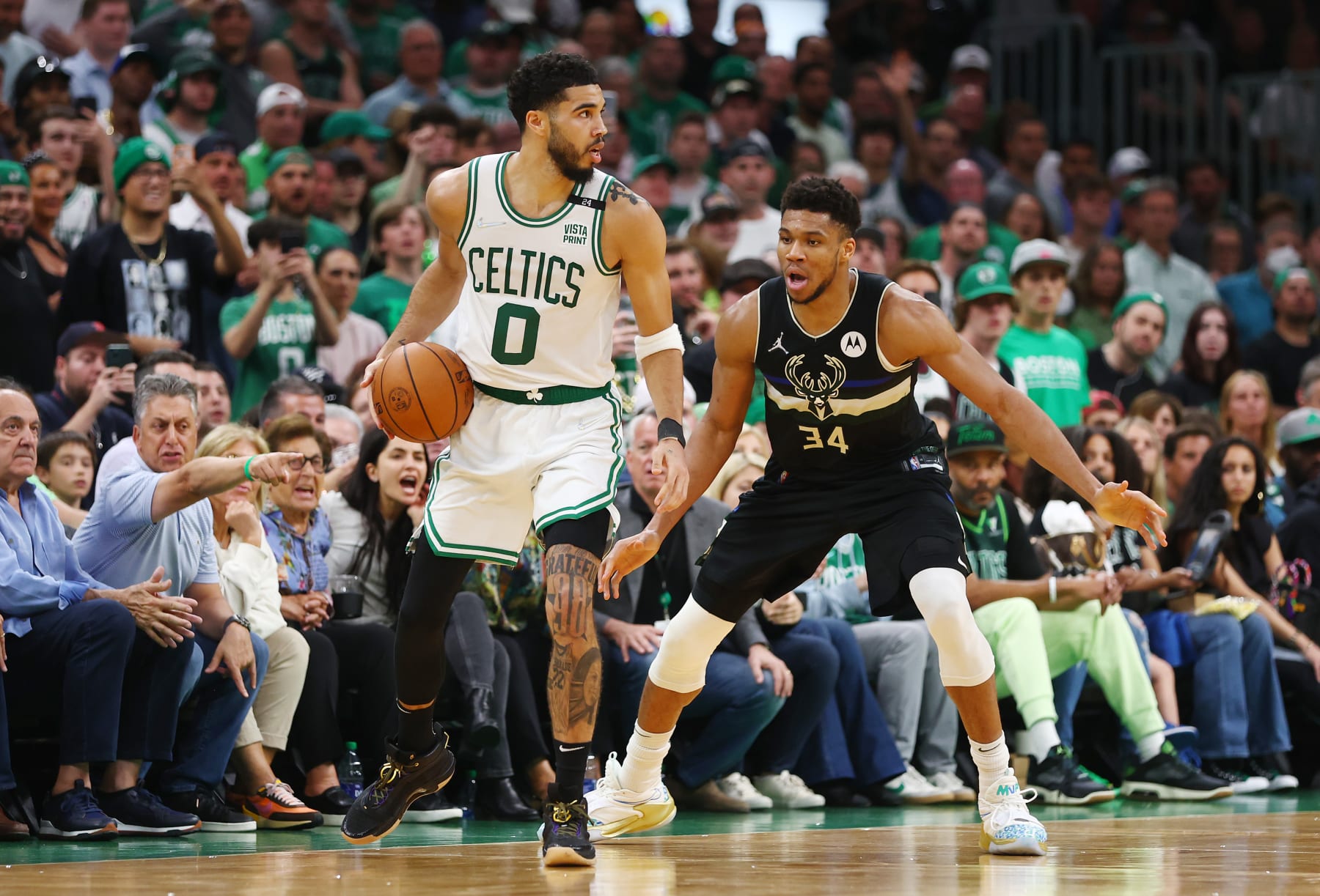 BOSTON, MASSACHUSETTS - MAY 15: Jayson Tatum #0 of the Boston Celtics handles the ball against Giannis Antetokounmpo #34 of the Milwaukee Bucks during the fourth quarter in Game Seven of the 2022 NBA Playoffs Eastern Conference Semifinals at TD Garden on May 15, 2022 in Boston, Massachusetts. NOTE TO USER: User expressly acknowledges and agrees that, by downloading and/or using this photograph, User is consenting to the terms and conditions of the Getty Images License Agreement. (Photo by Adam Glanzman/Getty Images)