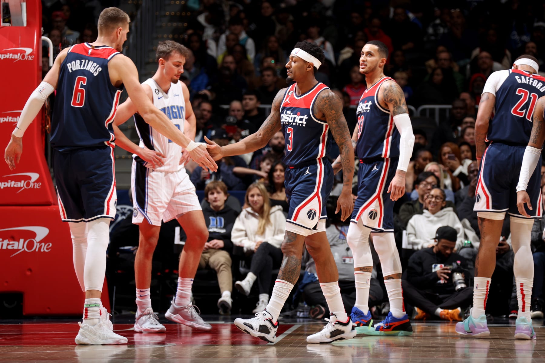 WASHINGTON, DC -  JANUARY 21: Kristaps Porzingis #6 and /223/ high fives during the game against the Orlando Magic on January 21, 2023 at Capital One Arena in Washington, DC. NOTE TO USER: User expressly acknowledges and agrees that, by downloading and or using this Photograph, user is consenting to the terms and conditions of the Getty Images License Agreement. Mandatory Copyright Notice: Copyright 2023 NBAE (Photo by Stephen Gosling/NBAE via Getty Images)