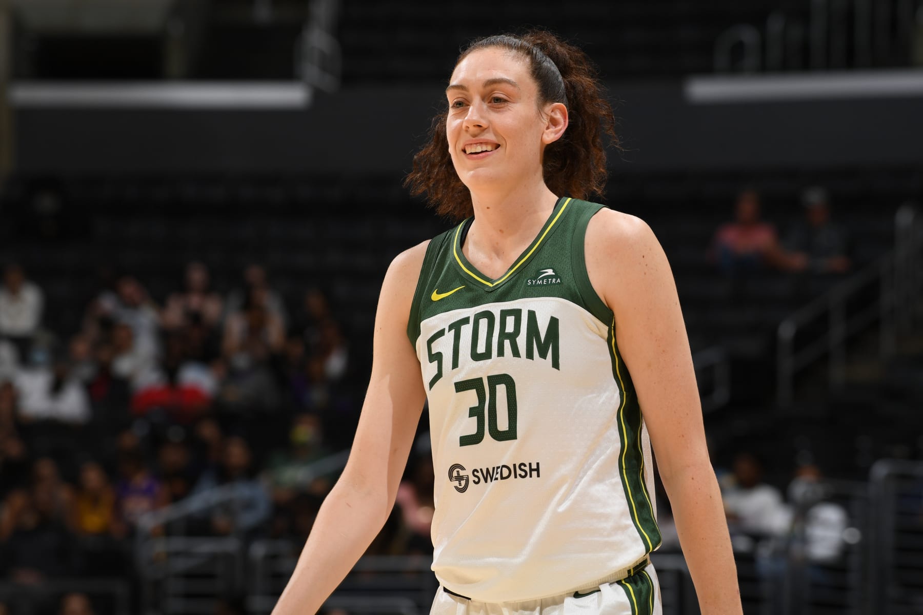 LOS ANGELES, CA - JULY 7: Breanna Stewart #30 of the Seattle Storm looks on and smiles during the game against the Los Angeles Sparks on July 7, 2022 at Crypto.com Arena in Los Angeles, California. NOTE TO USER: User expressly acknowledges and agrees that, by downloading and/or using this Photograph, user is consenting to the terms and conditions of the Getty Images License Agreement. Mandatory Copyright Notice: Copyright 2022 NBAE (Photo by Juan Ocampo/NBAE via Getty Images)