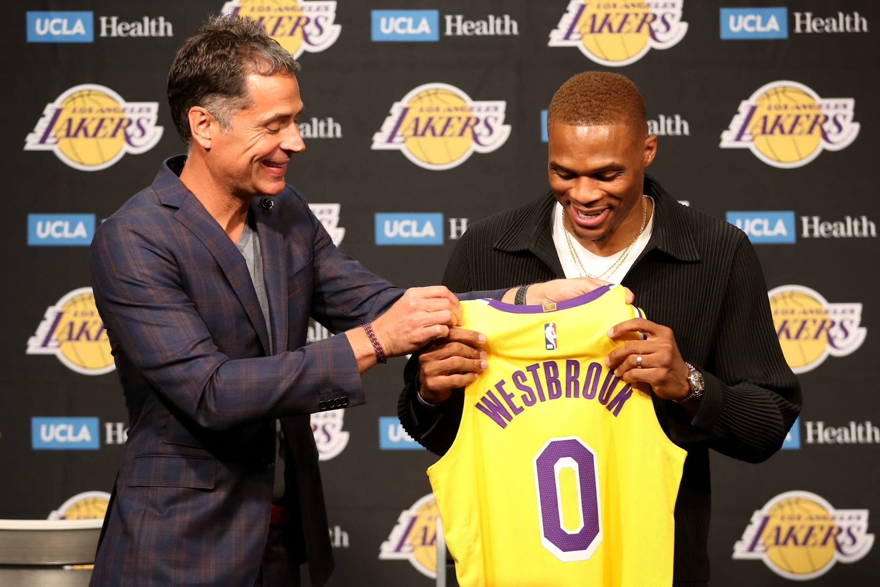 LOS ANGELES, CALIFORNIA - AUGUST 10: General manager Rob Pelinka gives Russell Westbrook #0 of the Los Angeles Lakers his jersey during a press conference at Staples Center on August 10, 2021 in Los Angeles, California. (Photo by Katelyn Mulcahy/Getty Images)