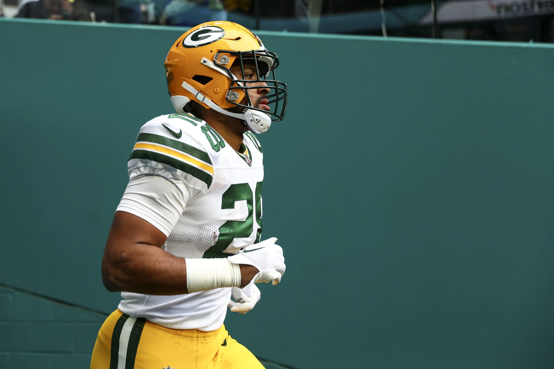 MIAMI GARDENS, FL - DECEMBER 25: AJ Dillon #28 of the Green Bay Packers runs out of the tunnel before an NFL football game against the Miami Dolphins at Hard Rock Stadium on December 25, 2022 in Miami Gardens, Florida. (Photo by Kevin Sabitus/Getty Images)