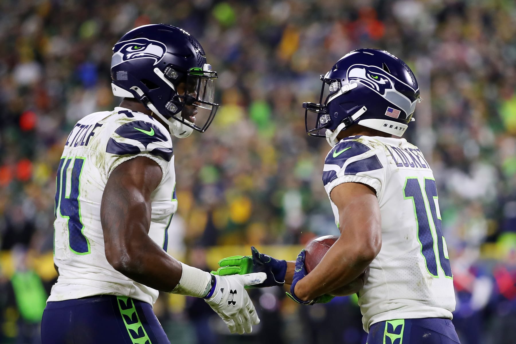 GREEN BAY, WISCONSIN - JANUARY 12: Tyler Lockett #16 of the Seattle Seahawks celebrates with DK Metcalf #14 after scoring a touchdown during the third quarter against the Green Bay Packers in the NFC Divisional Playoff game at Lambeau Field on January 12, 2020 in Green Bay, Wisconsin. (Photo by Gregory Shamus/Getty Images)