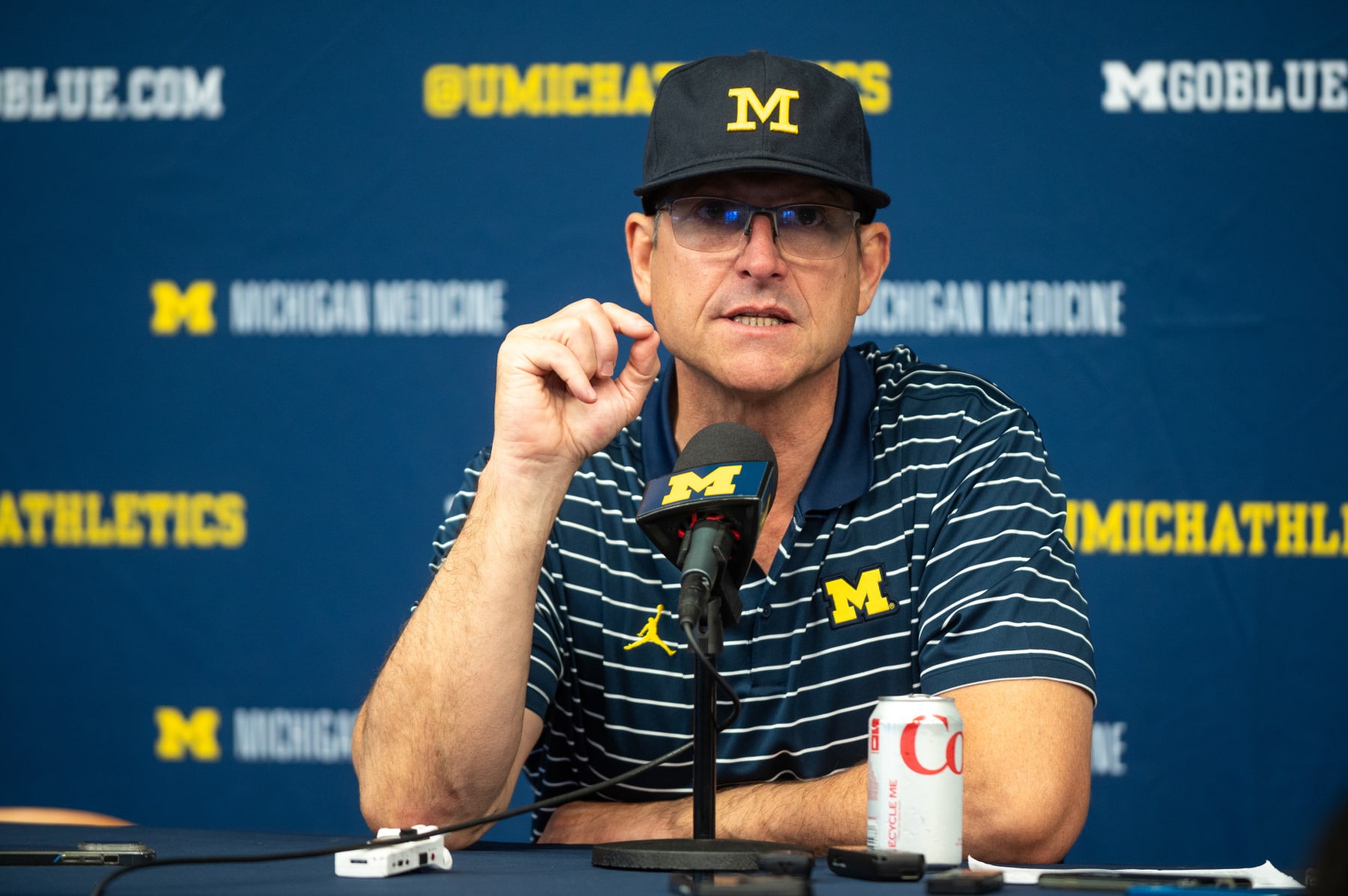 ANN ARBOR, MICHIGAN - OCTOBER 14: Head Coach Jim Harbaugh of the Michigan Wolverines speaks to media during the post-game press conference after a college football game against the Indiana Hoosiers at Michigan Stadium on October 14, 2023 in Ann Arbor, Michigan. The Michigan Wolverines won the game 52-7. (Photo by Aaron J. Thornton/Getty Images)