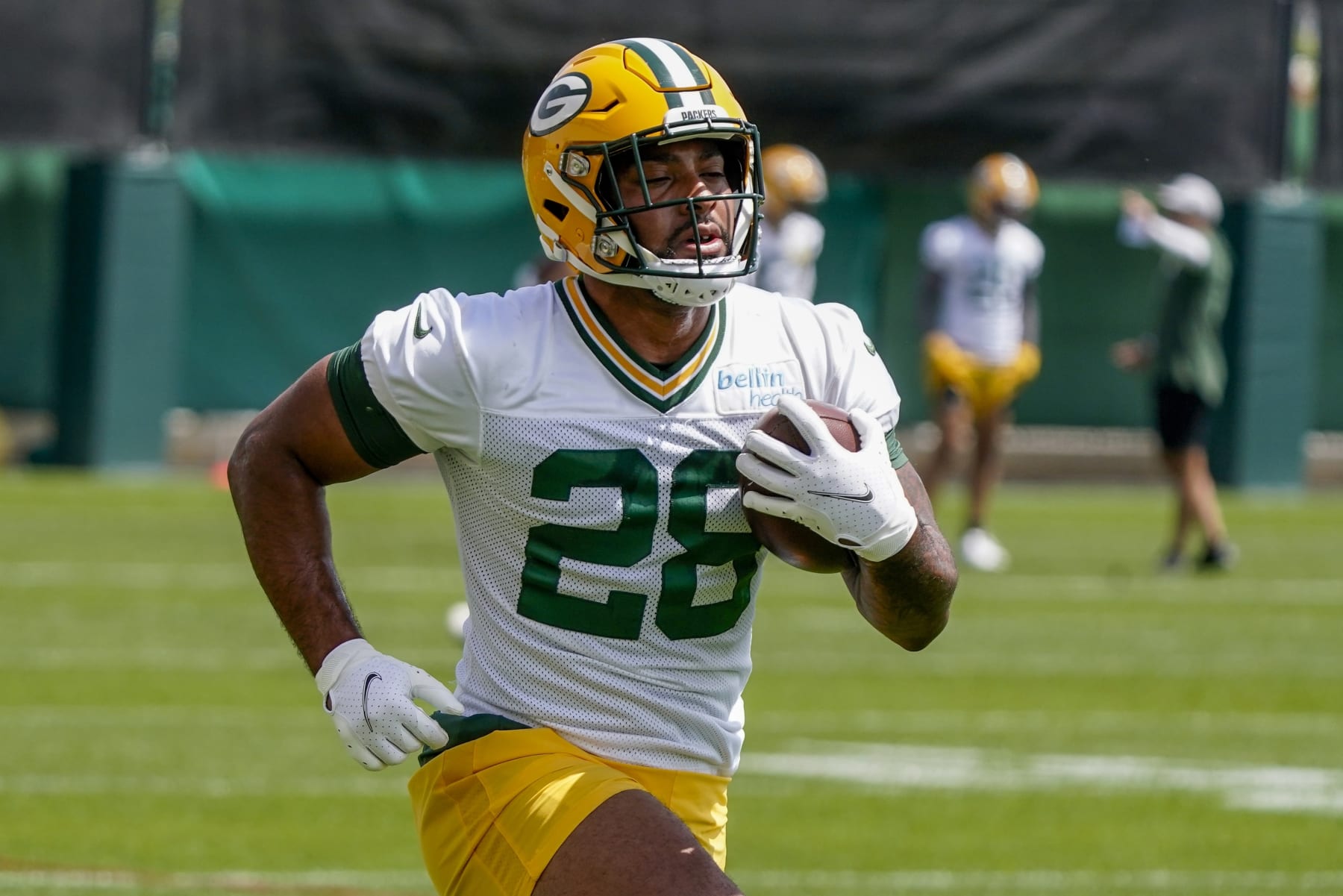 Green Bay Packers' AJ Dillon runs a drill at the NFL football team's practice field training camp Tuesday, May 24, 2022, in Green Bay, Wis. (AP Photo/Morry Gash)