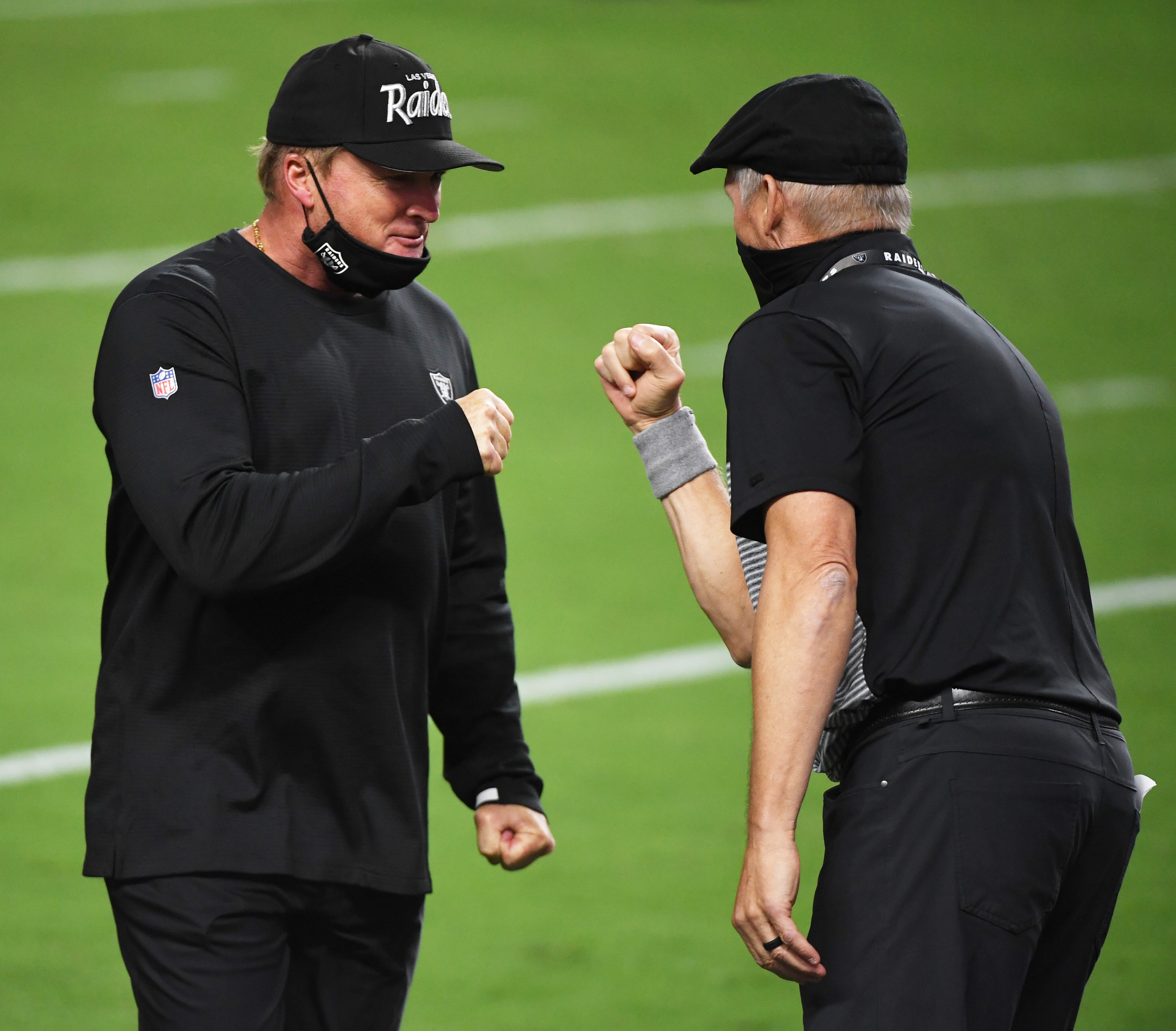 LAS VEGAS, NEVADA - SEPTEMBER 21:  Head coach Jon Gruden (L) and general manager Mike Mayock of the Las Vegas Raiders celebrate on the field after the Raiders defeated the New Orleans Saints 34-24 in the NFL game at Allegiant Stadium on September 21, 2020 in Las Vegas, Nevada.  (Photo by Ethan Miller/Getty Images)
