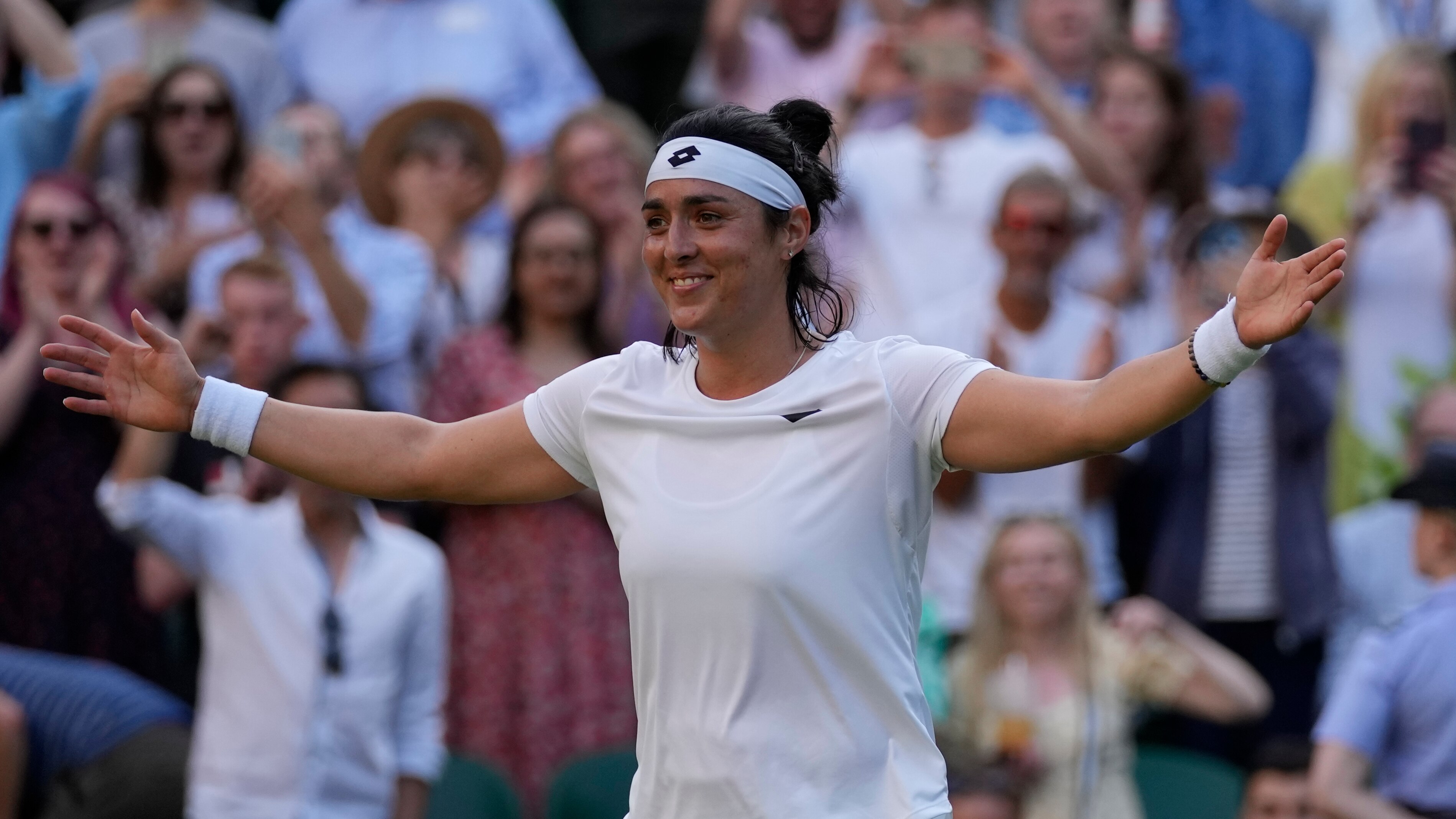 Tunisia's Ons Jabeur reacts after beating Marie Bouzkova of the Czech Republic in a women's singles quarterfinal match on day nine of the Wimbledon tennis championships in London, Tuesday, July 5, 2022. (AP Photo/Alastair Grant)