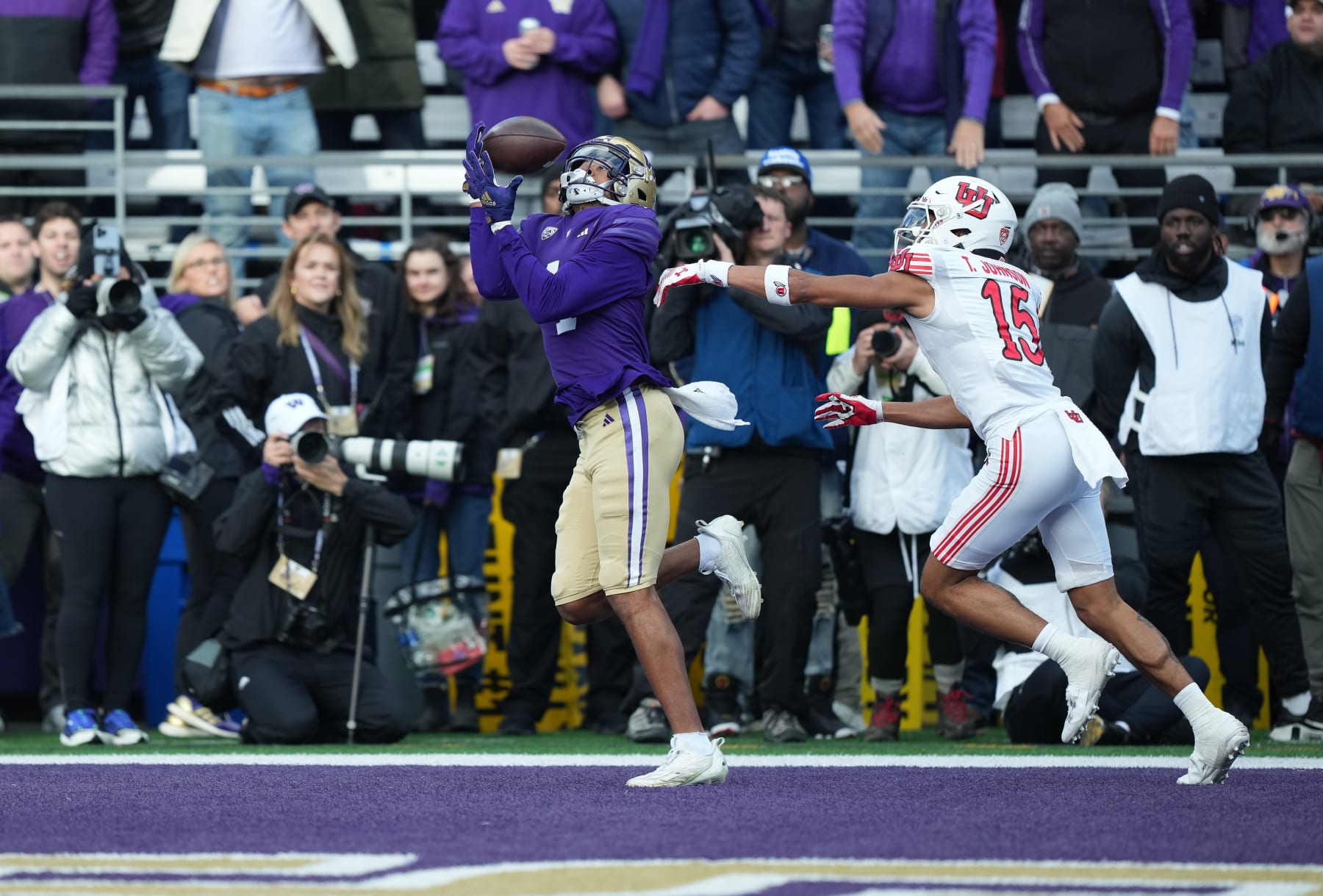 SEATTLE, WA - NOVEMBER 11: Washington Huskies wide receiver Rome Odunze (1) pulls in a pass for a Washington touchdown in front of Utah Utes cornerback Tao Johnson (15) during a PAC12 game between the Washington Huskies and the Utah Utes on Nov 11, 2023 at Husky Stadium in Seattle, WA. (Photo by Jeff Halstead/Icon Sportswire via Getty Images)