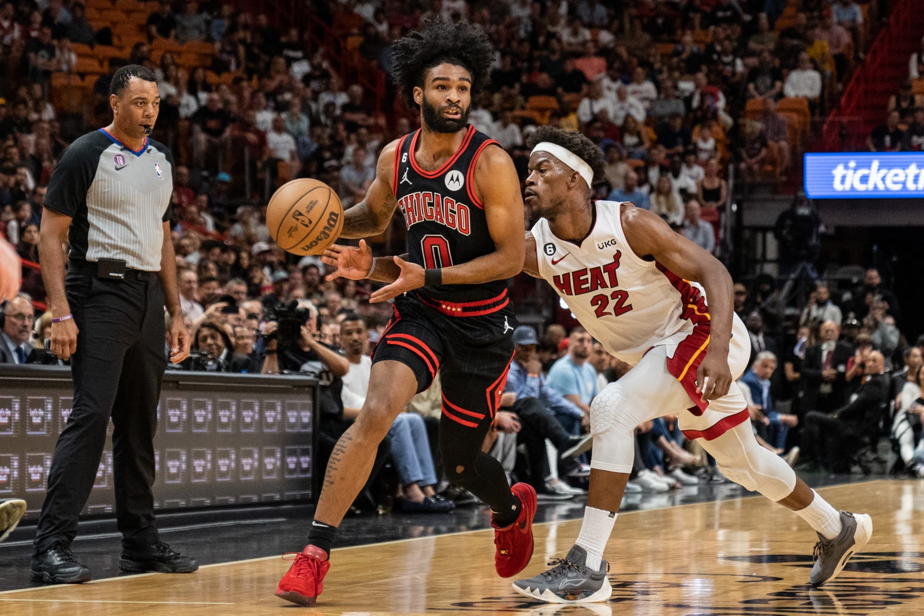 MIAMI, FL - APRIL 14: Jimmy Butler #22 of the Miami Heat attempts to steal the ball from Coby White #0 of the Chicago Bulls at Kaseya Center on April 14, 2023 in Miami, Florida.  NOTE TO USER: User expressly acknowledges and agrees that, by downloading and or using this Photograph, user is consenting to the terms and conditions of the Getty Images License Agreement. (Photo by Bryan Cereijo/Getty Images)