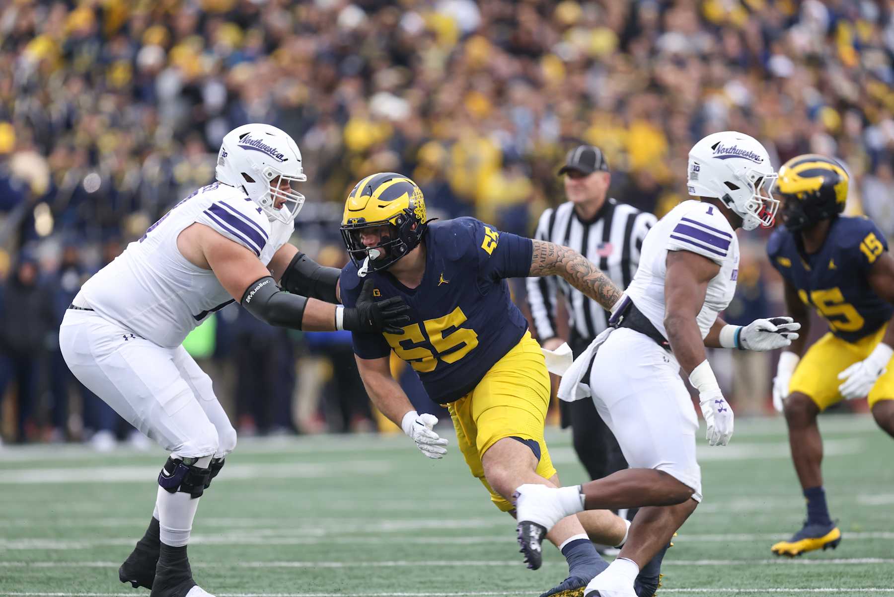 ANN ARBOR, MI - NOVEMBER 23:  Michigan Wolverines defensive lineman Mason Graham (55) rushes during a play during a regular season Big Ten Conference college football game between the Northwestern Wildcats and the Michigan Wolverines on November 23, 2024 at Michigan Stadium in Ann Arbor, Michigan. (Photo by Scott W. Grau/Icon Sportswire via Getty Images)