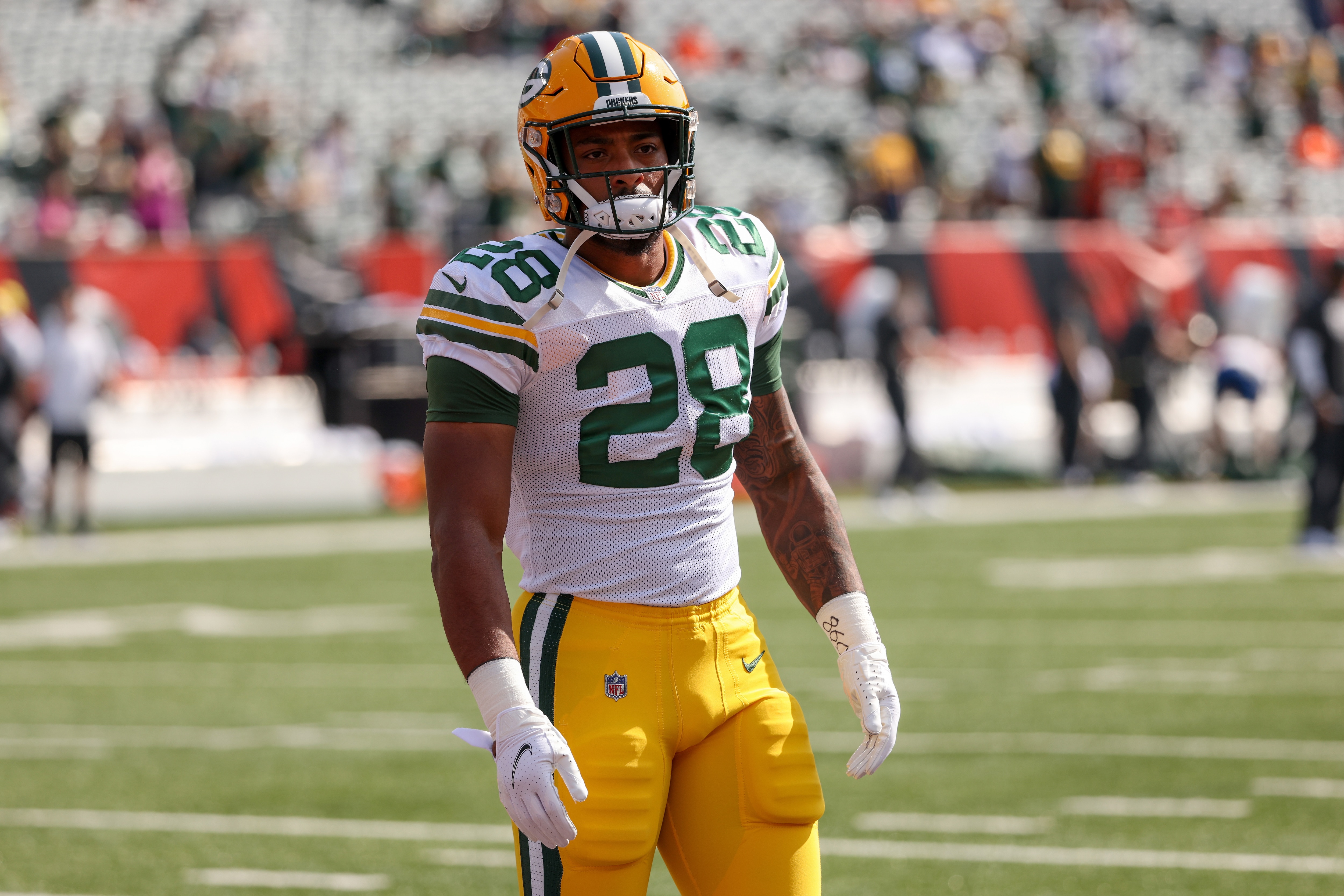 CINCINNATI, OHIO - OCTOBER 10: AJ Dillon #28 of the Green Bay Packers warms up before the game against the Cincinnati Bengals at Paul Brown Stadium on October 10, 2021 in Cincinnati, Ohio. (Photo by Dylan Buell/Getty Images)