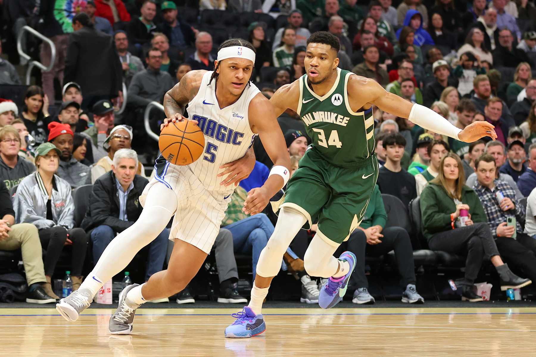 MILWAUKEE, WISCONSIN - DECEMBER 21: Paolo Banchero #5 of the Orlando Magic is defended by Giannis Antetokounmpo #34 of the Milwaukee Bucks during a game at Fiserv Forum on December 21, 2023 in Milwaukee, Wisconsin. NOTE TO USER: User expressly acknowledges and agrees that, by downloading and or using this photograph, User is consenting to the terms and conditions of the Getty Images License Agreement. (Photo by Stacy Revere/Getty Images)