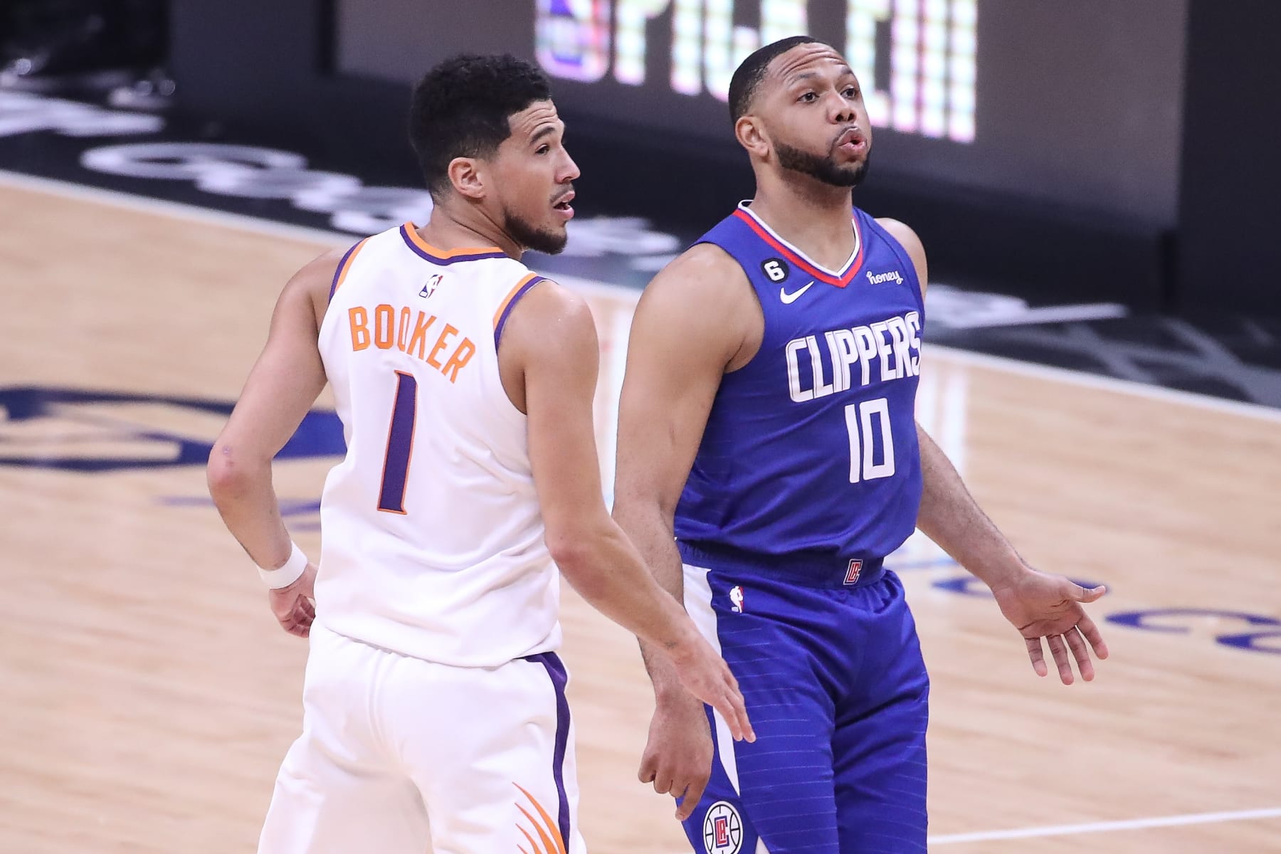 LOS ANGELES, CA - APRIL 20: LA Clippers guard Eric Gordon (10) watches his shot with Phoenix Suns guard Devin Booker (1) during the Phoenix Suns game versus the Los Angeles Clippers in Game 3 of the West 1st Round on April 20, 2023, at Crypto.com Arena in Los Angeles, CA. (Photo by Jevone Moore/Icon Sportswire via Getty Images)