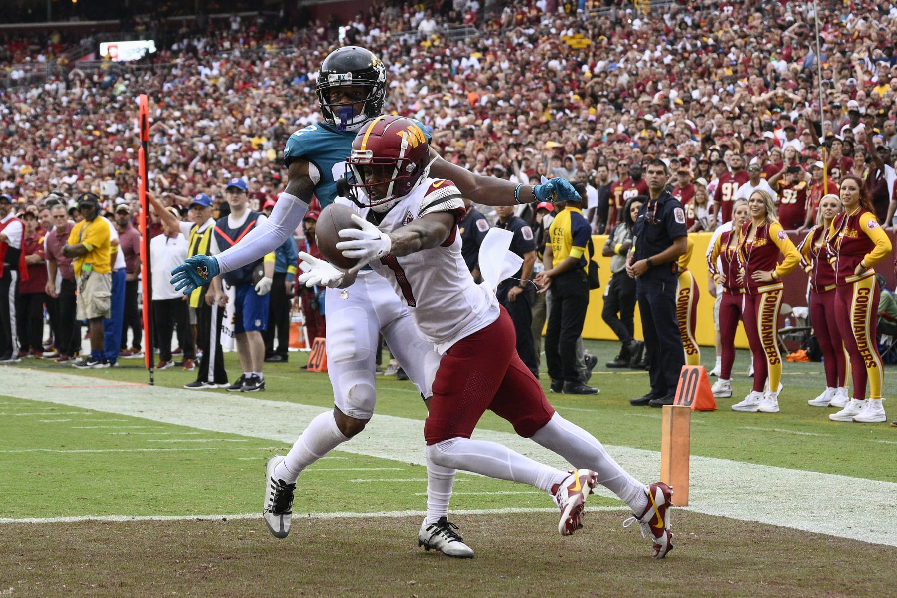 Washington Commanders wide receiver Jahan Dotson (1) catches a touchdown pass against Jacksonville Jaguars cornerback Tyson Campbell (32) during the second half of an NFL football game, Sunday, Sept. 11, 2022, in Landover, Md. (AP Photo/Nick Wass)