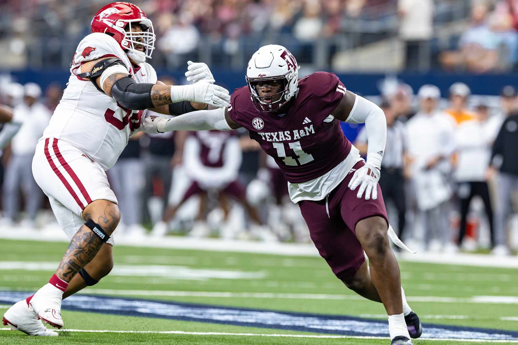 ARLINGTON, TX - SEPTEMBER 28: Texas A&M Aggies defensive end Nic Scourton (#11) gets around Arkansas Razorbacks tackle Keyshawn Blackstock (#54) during the college football game between the Arkansas Razorbacks and Texas A&M Aggies on September 28, 2024, at AT&T Stadium in Arlington, TX.  (Photo by Matthew Visinsky/Icon Sportswire via Getty Images)