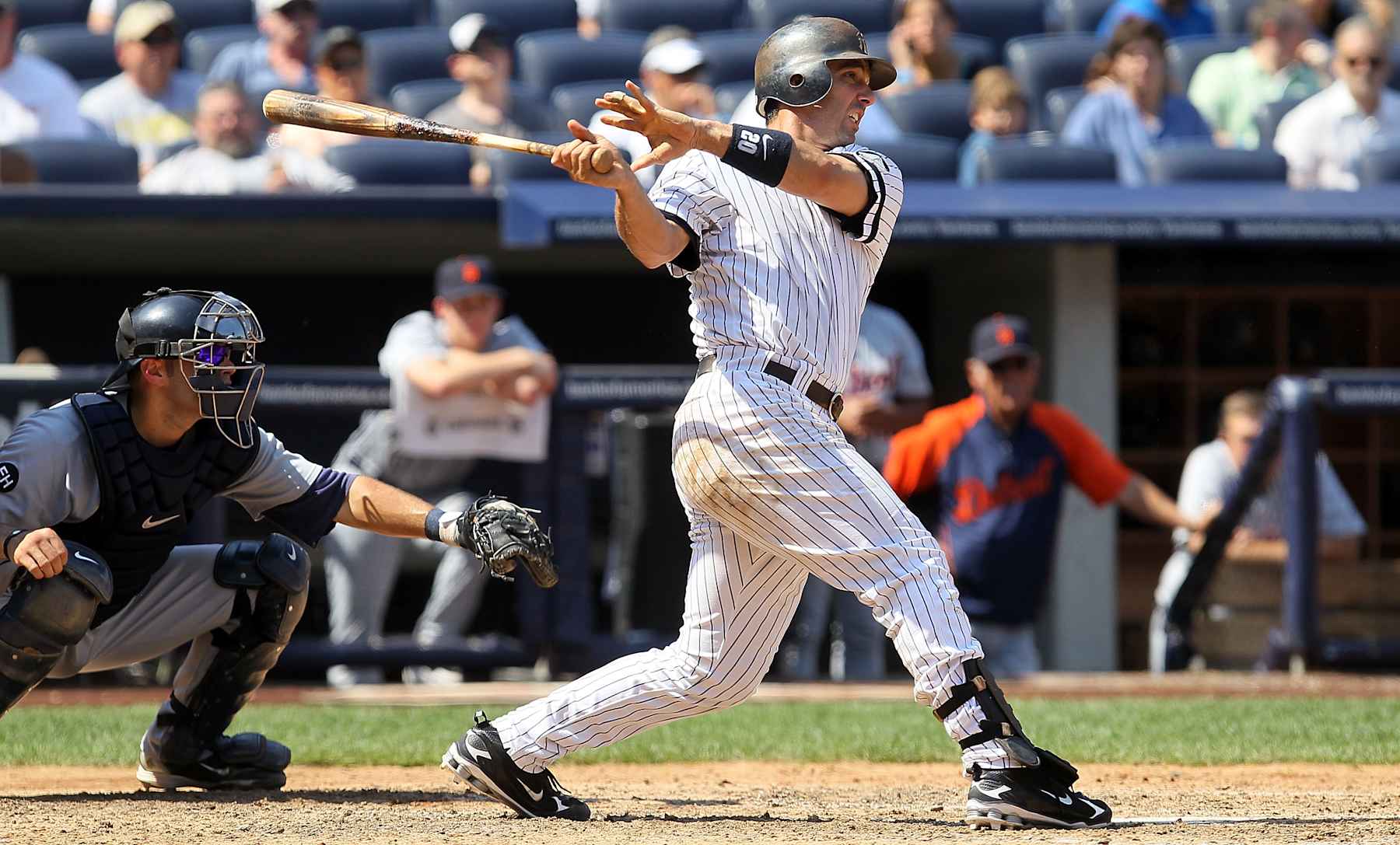 NEW YORK - AUGUST 19:  Jorge Posada #20 of the New York Yankees follows through on a sixth inning RBI single against the Detroit Tigers on August 19, 2010 at Yankee Stadium in the Bronx borough of New York City.  (Photo by Jim McIsaac/Getty Images)