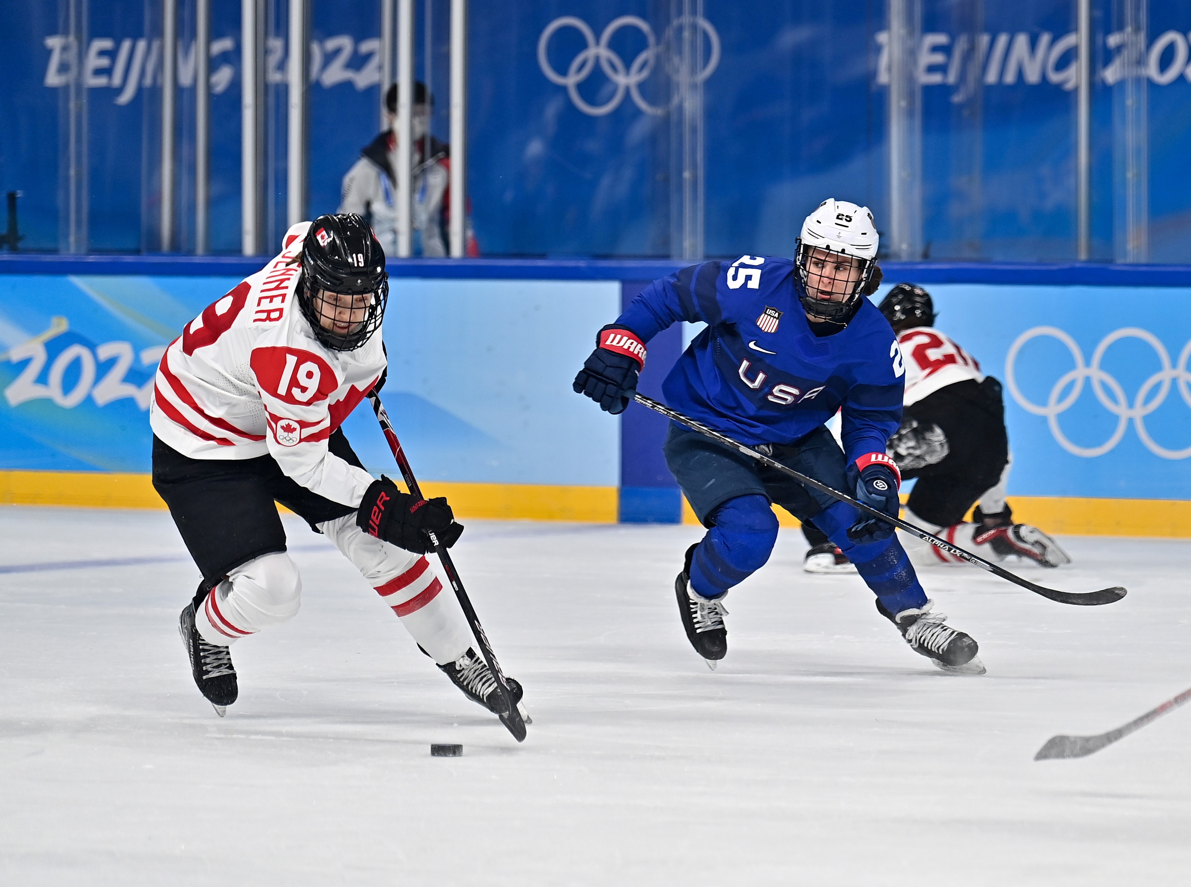 Alex Carpenter R of the United States vies with Brianne Jenner of Canada during the ice hockey women's preliminary round group A match between Canada and the United States at Wukesong Sports Centre in Beijing, capital of China, Feb. 8, 2022. (Photo by Song Yanhua/Xinhua via Getty Images)