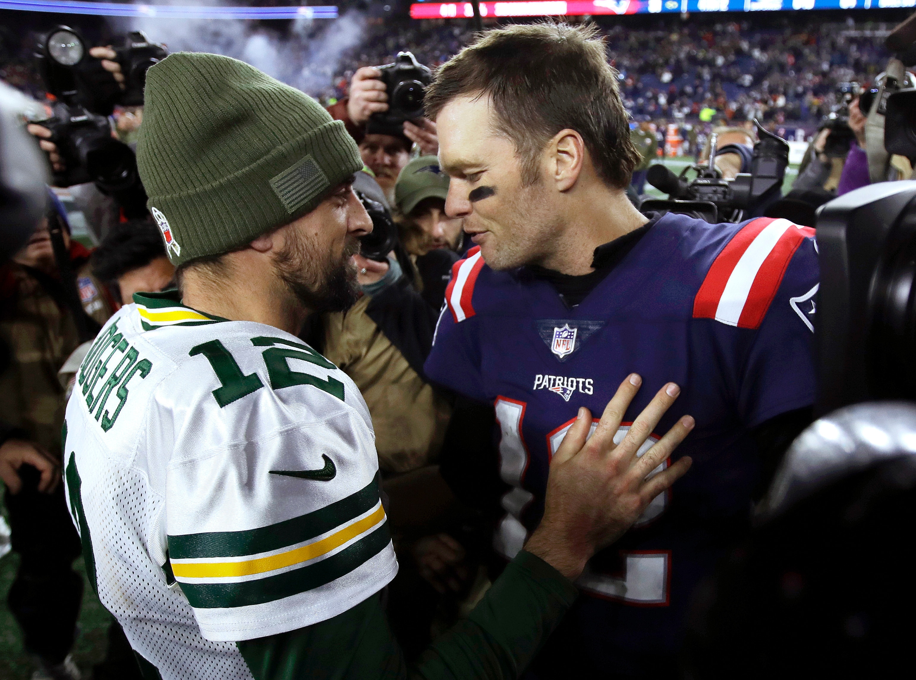 Green Bay Packers quarterback Aaron Rodgers, left, and New England Patriots quarterback Tom Brady speak at midfield after an NFL football game, Sunday, Nov. 4, 2018, in Foxborough, Mass. (AP Photo/Charles Krupa)
