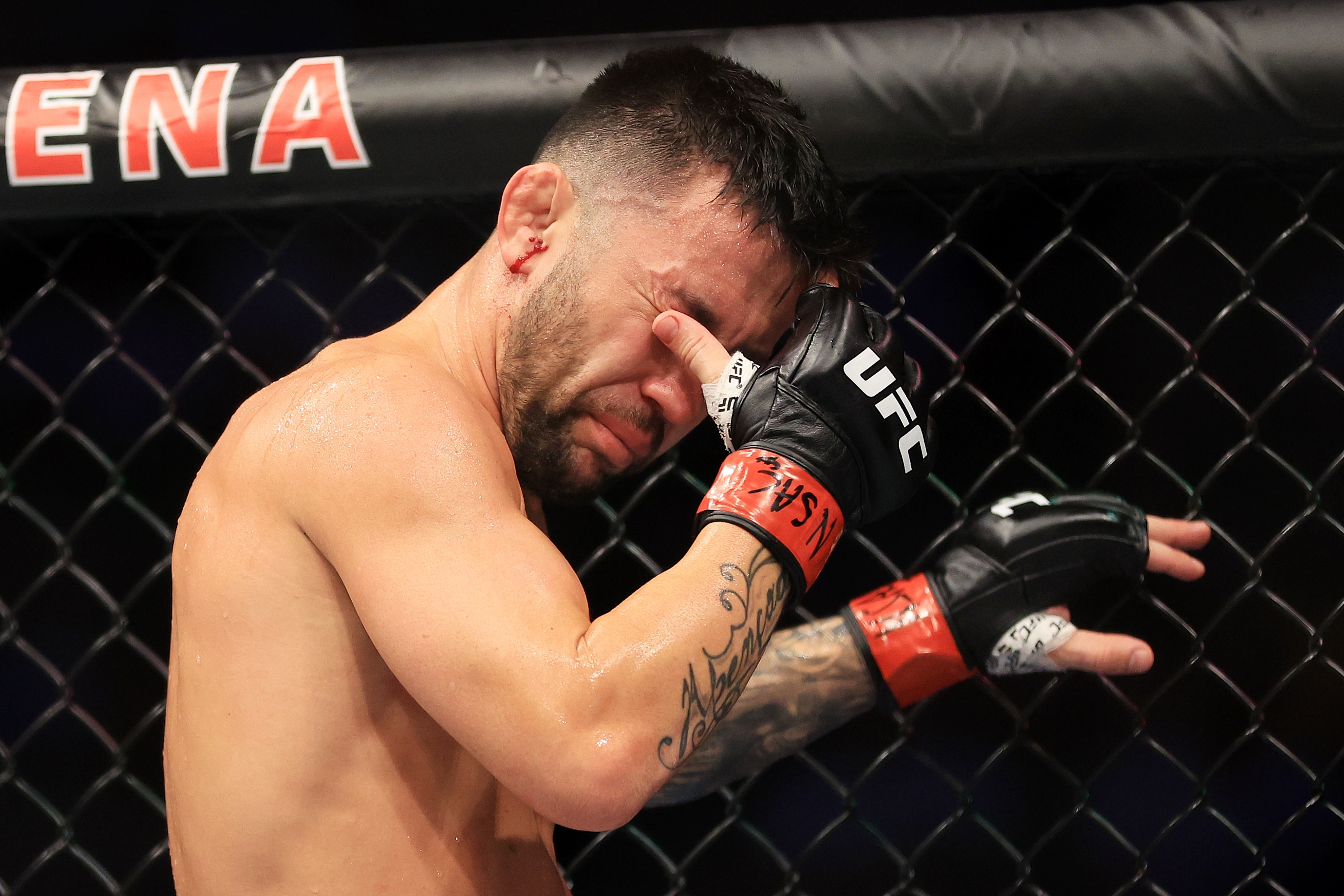 LAS VEGAS, NEVADA - JULY 02: Pedro Munhoz of Brazil reacts after an unintentional eye poke from Sean O'Malley in their bantamweight bout during UFC 276 at T-Mobile Arena on July 02, 2022 in Las Vegas, Nevada. The fight was ruled a no contest. (Photo by Carmen Mandato/Getty Images)