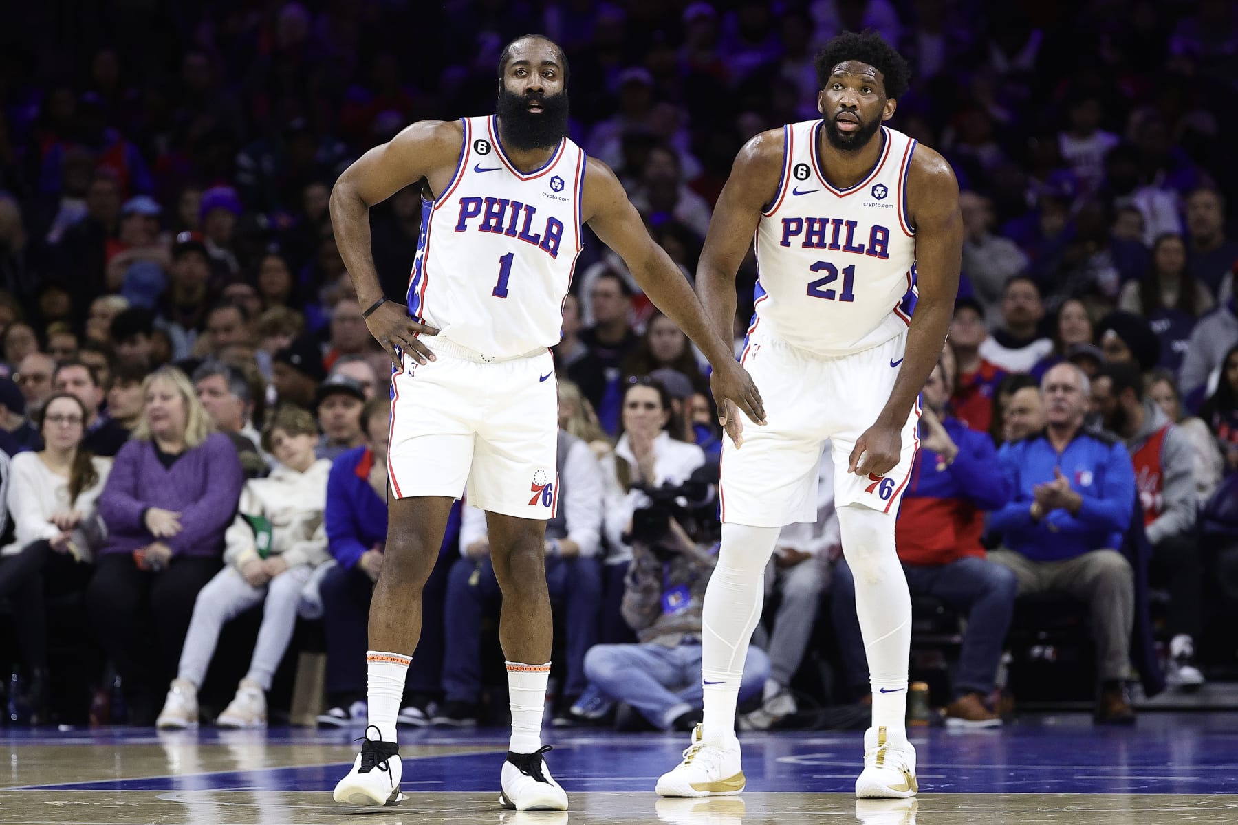 PHILADELPHIA, PENNSYLVANIA - DECEMBER 19: James Harden #1 and Joel Embiid #21 of the Philadelphia 76ers look on during the first quarter against the Toronto Raptors at Wells Fargo Center on December 19, 2022 in Philadelphia, Pennsylvania. NOTE TO USER: User expressly acknowledges and agrees that, by downloading and or using this photograph, User is consenting to the terms and conditions of the Getty Images License Agreement. (Photo by Tim Nwachukwu/Getty Images)