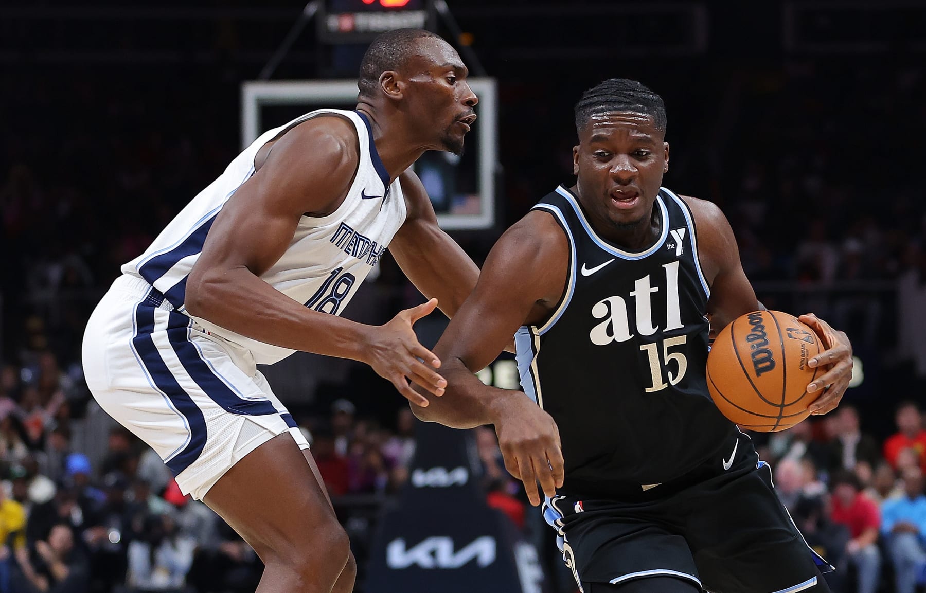 ATLANTA, GEORGIA - DECEMBER 23:  Clint Capela #15 of the Atlanta Hawks pushes the ball against Bismack Biyombo #18 of the Memphis Grizzlies during the first quarter at State Farm Arena on December 23, 2023 in Atlanta, Georgia.  NOTE TO USER: User expressly acknowledges and agrees that, by downloading and/or using this photograph, user is consenting to the terms and conditions of the Getty Images License Agreement. (Photo by Kevin C. Cox/Getty Images)