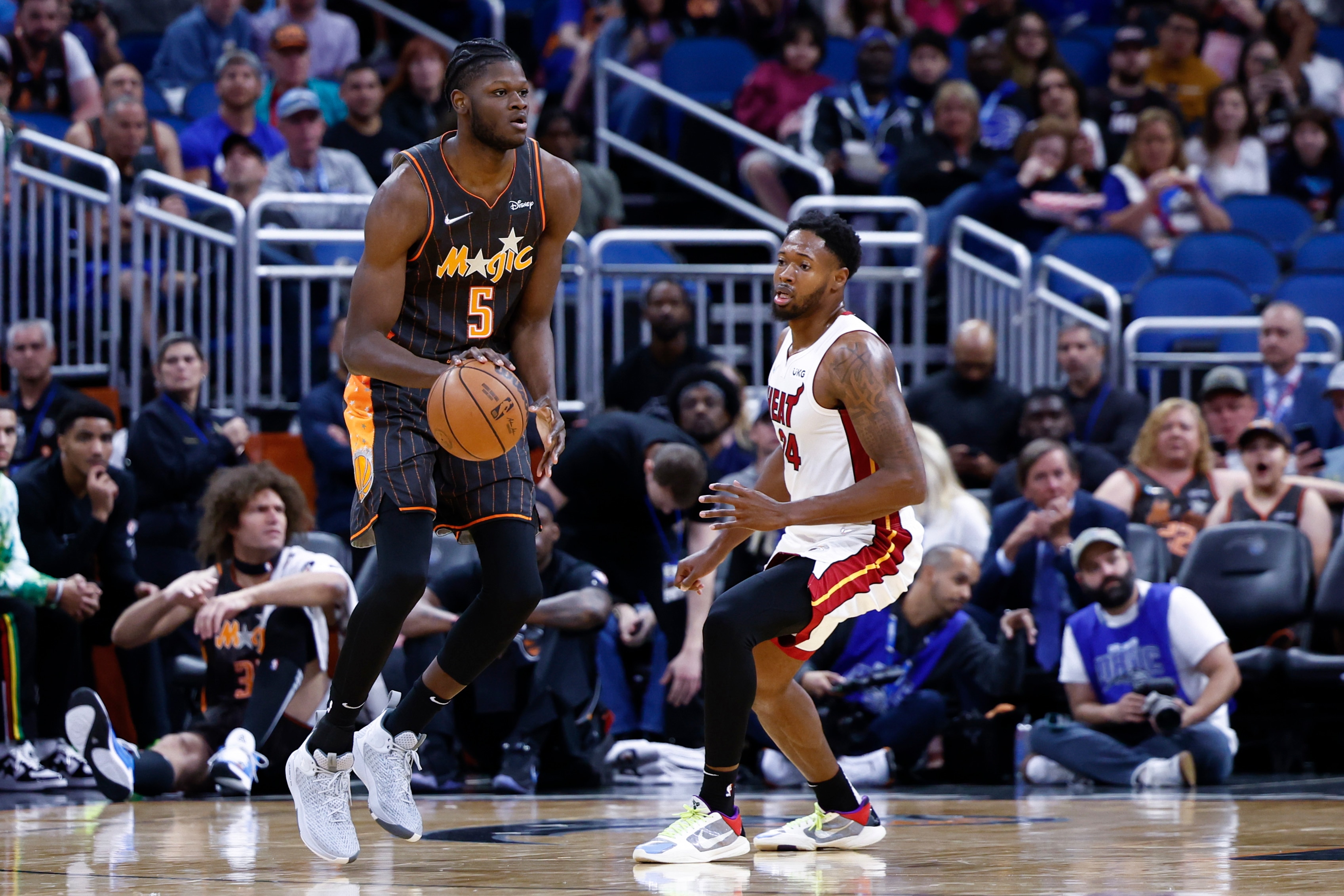ORLANDO, FLORIDA - APRIL 10: Mo Bamba #5 of the Orlando Magic dribbles the ball as Haywood Highsmith #24 of the Miami Heat defends during the first quarter at Amway Center on April 10, 2022 in Orlando, Florida. NOTE TO USER: User expressly acknowledges and agrees that, by downloading and or using this photograph, User is consenting to the terms and conditions of the Getty Images License Agreement. (Photo by Douglas P. DeFelice/Getty Images)