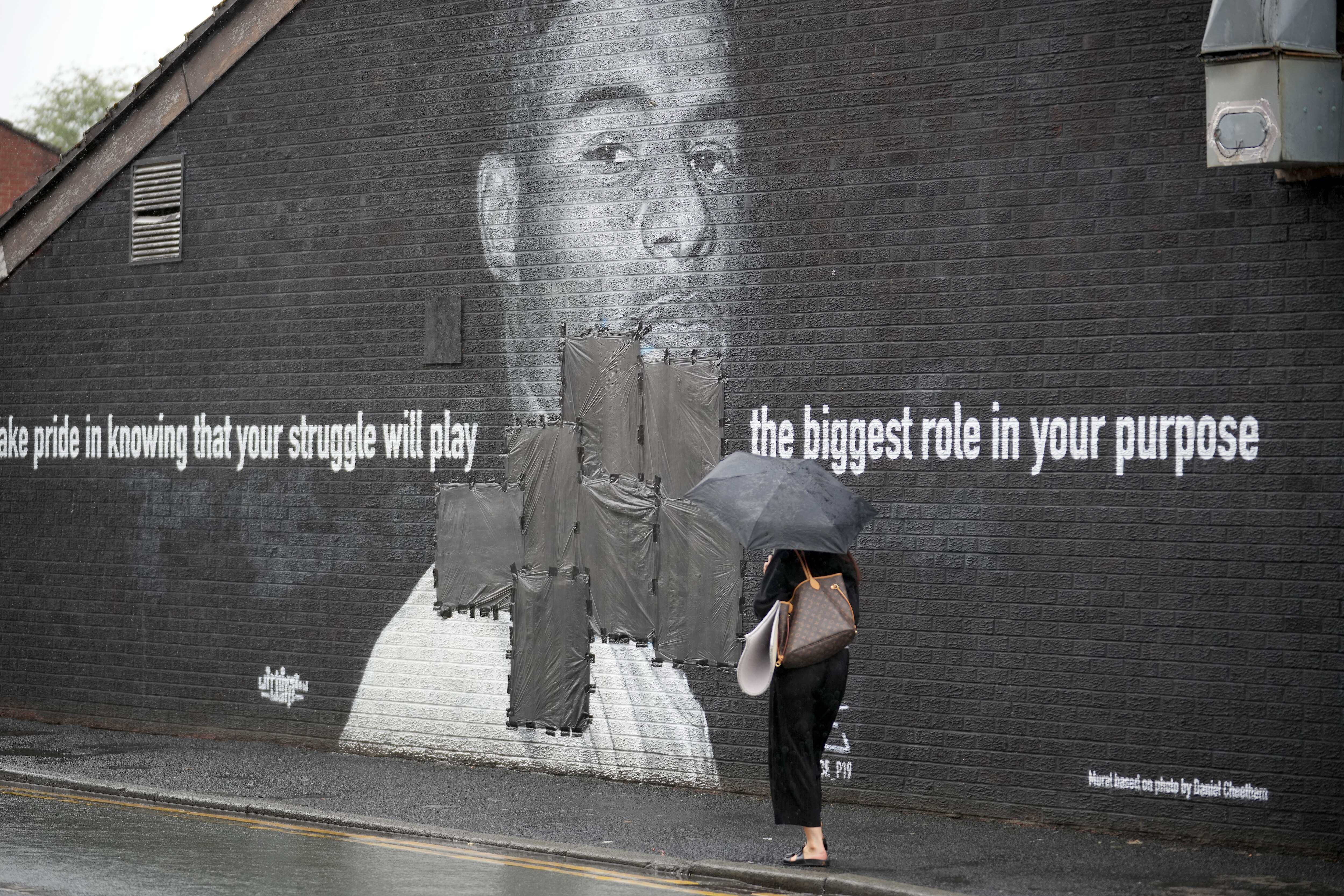 MANCHESTER, ENGLAND - JULY 12:  Bin bags cover offensive graffiti on the vandalised mural of Manchester United striker and England player Marcus Rashford on the wall of a cafe on Copson Street, Withington on July 12, 2021 in Manchester, England. Rashford and other Black players on England's national football team have been the target of racist abuse, largely on social media, after the team's loss to Italy in the UEFA European Football Championship last night. England manager Gareth Southgate, Prime Minister Boris Johnson, and the Football Association have issued statements condemning the abuse. (Photo by Christopher Furlong/Getty Images)