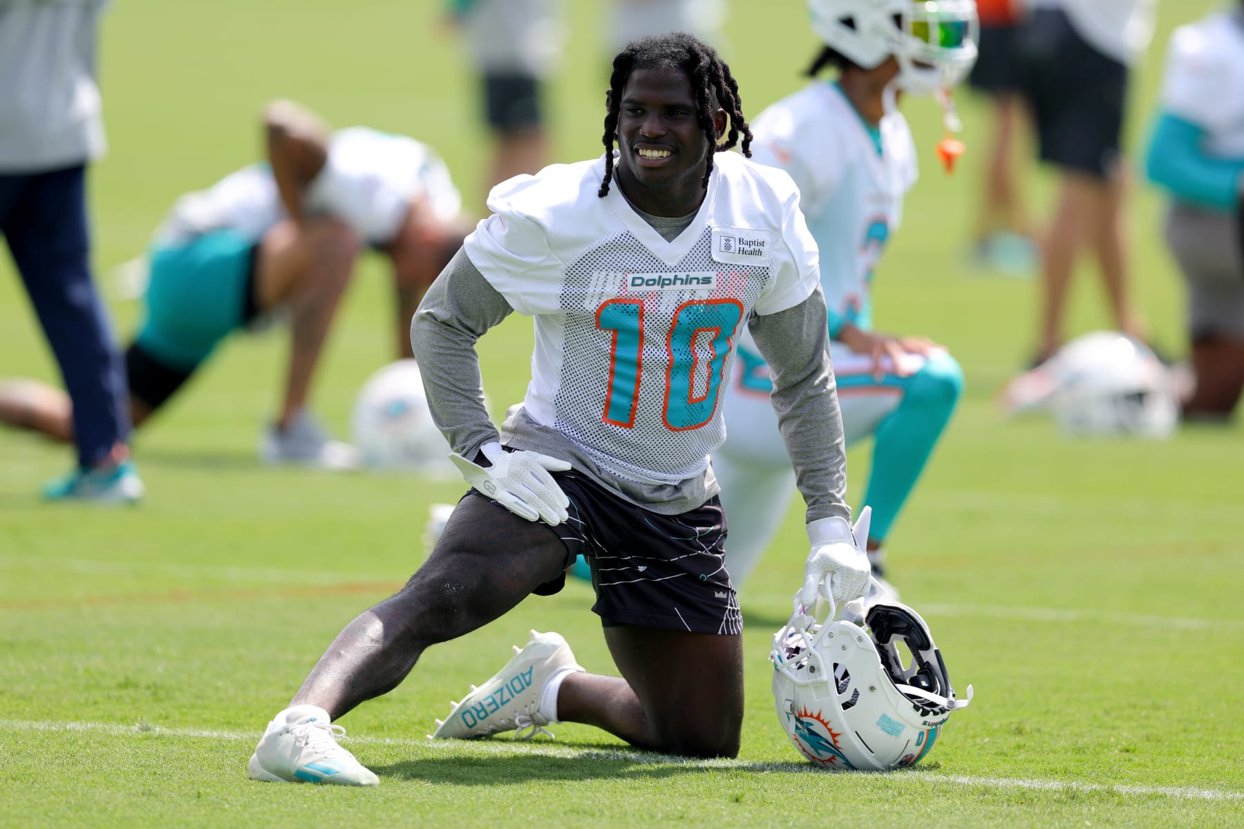 MIAMI GARDENS, FLORIDA - JUNE 08: Tyreek Hill #10 of the Miami Dolphins stretches prior to practice at Baptist Health Training Complex on June 08, 2023 in Miami Gardens, Florida. (Photo by Megan Briggs/Getty Images)