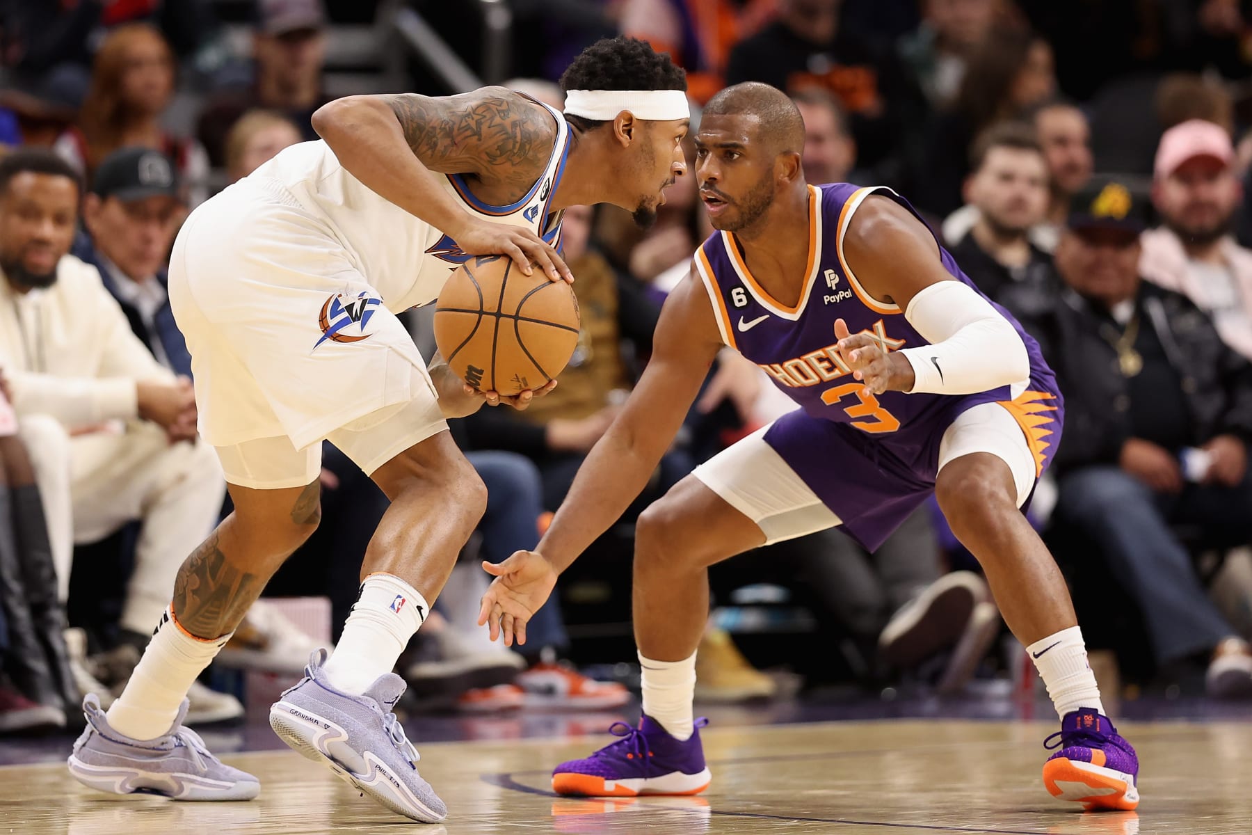 PHOENIX, ARIZONA - DECEMBER 20: Bradley Beal #3 of the Washington Wizards handles the ball against Chris Paul #3 of the Phoenix Suns during the first half of the NBA game at Footprint Center on December 20, 2022 in Phoenix, Arizona. The Wizards defeated the Suns 113-110.  NOTE TO USER: User expressly acknowledges and agrees that, by downloading and or using this photograph, User is consenting to the terms and conditions of the Getty Images License Agreement. (Photo by Christian Petersen/Getty Images)