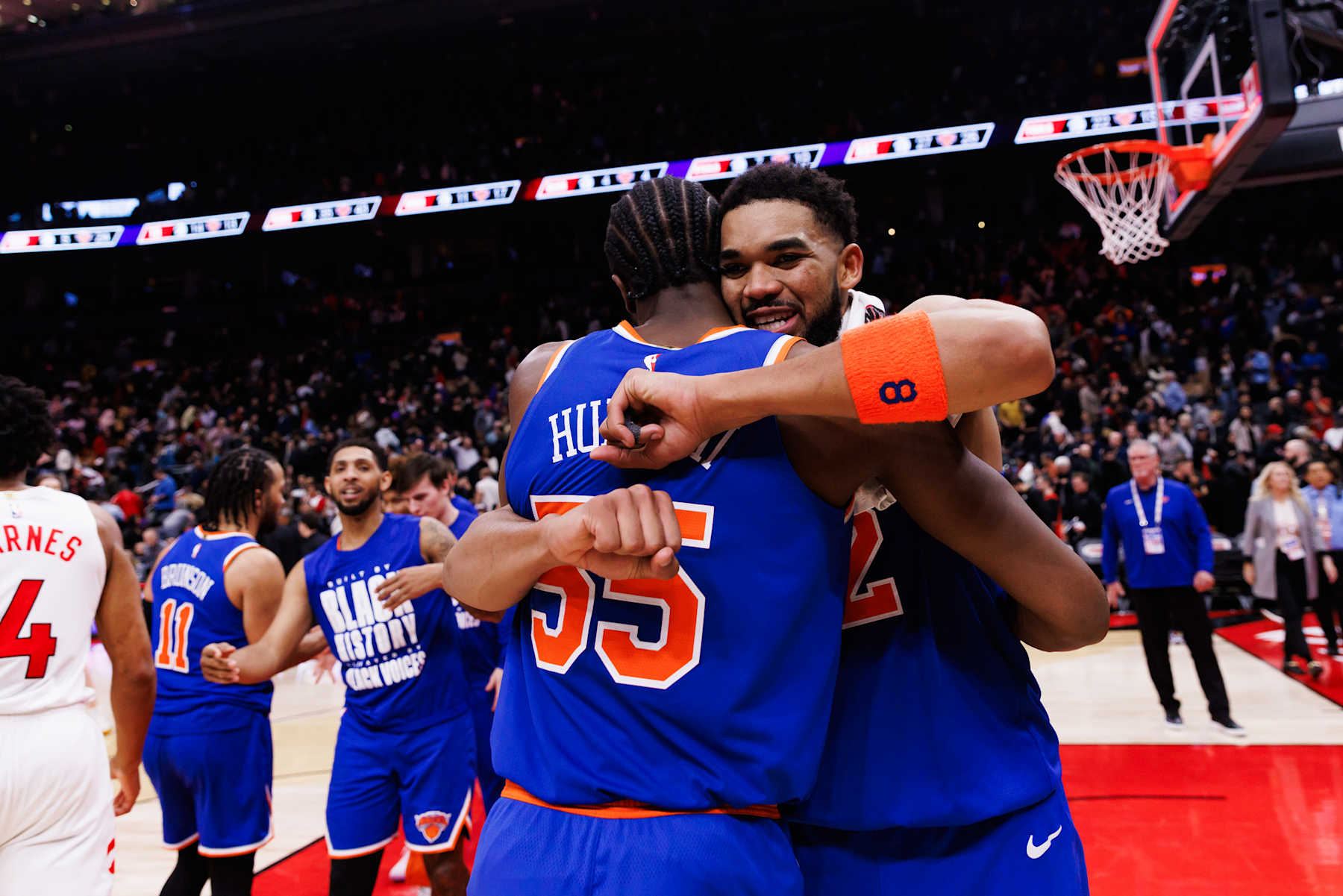 TORONTO, CANADA - FEBRUARY 4: Karl-Anthony Towns #32 of the New York Knicks hugs Ariel Hukporti #55 after the NBA game against the Toronto Raptors at Scotiabank Arena on February 4, 2025 in Toronto, Canada. NOTE TO USER: User expressly acknowledges and agrees that, by downloading and or using this photograph, User is consenting to the terms and conditions of the Getty Images License Agreement. (Photo by Cole Burston/Getty Images)