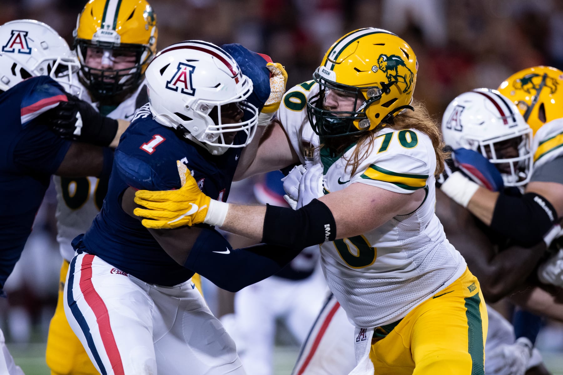 TUCSON, AZ - SEPTEMBER 17: North Dakota State Offensive Tackle Cody Mauch (70) makes a block on University of Arizona Defensive End Jalen Harris (1) during a College Football game between the University of Arizona Wildcats and the North Dakota State Bison on September 17, 2022, at Arizona Stadium in Tucson, AZ. (Photo by Zac BonDurant/Icon Sportswire via Getty Images)